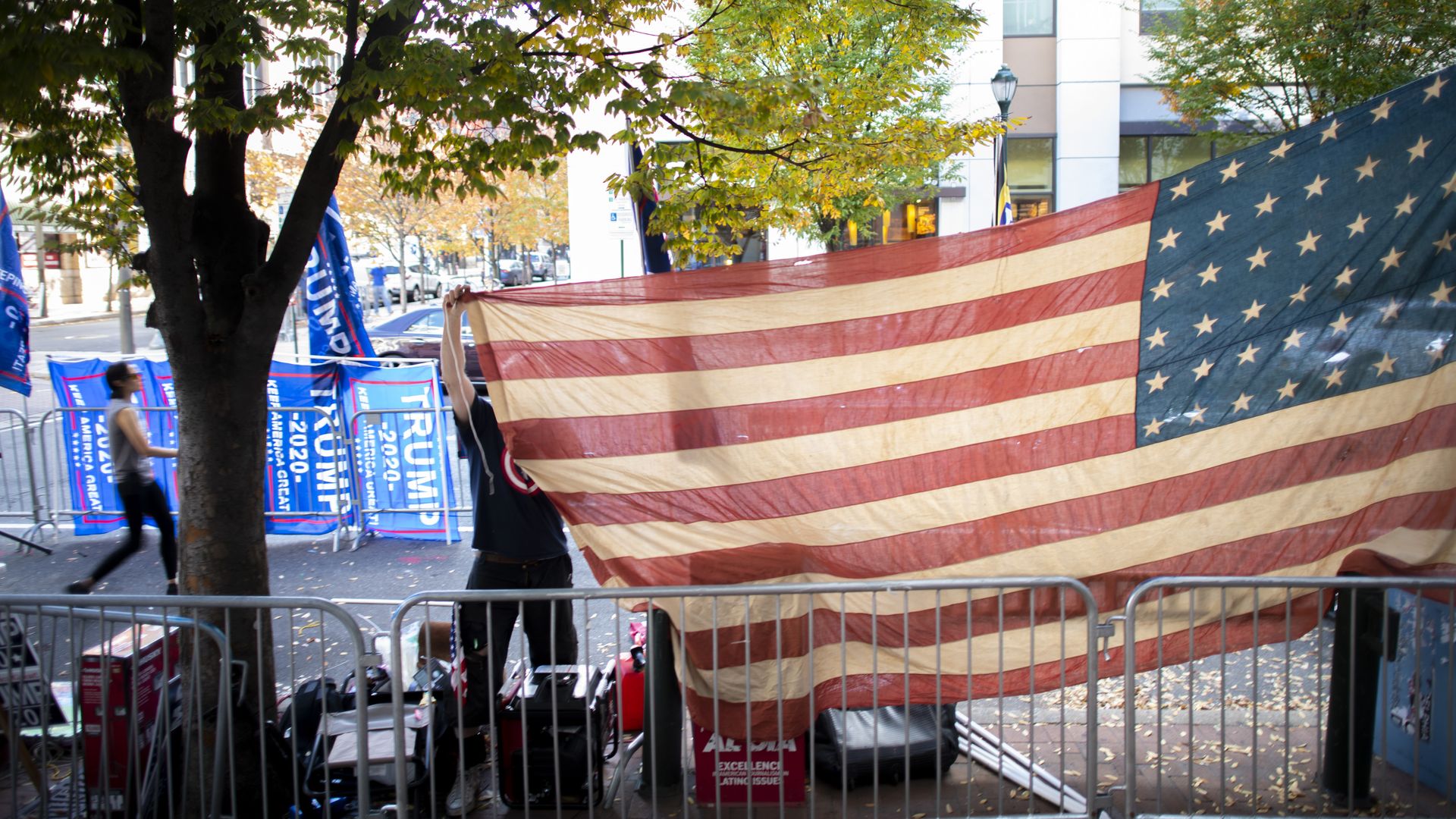 A Trump supporter raises an American flag