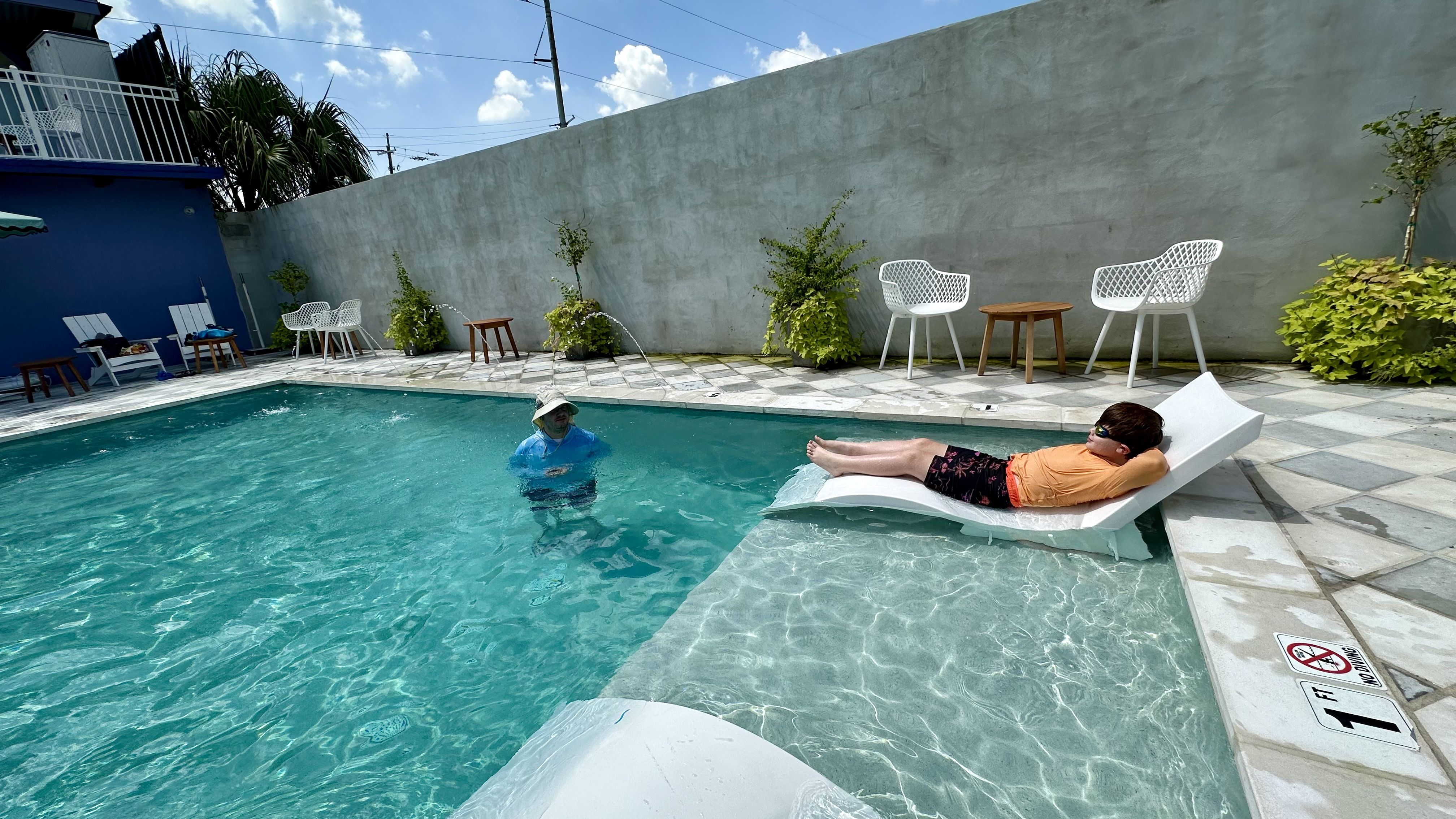 Photo shows two people playing in the pool.