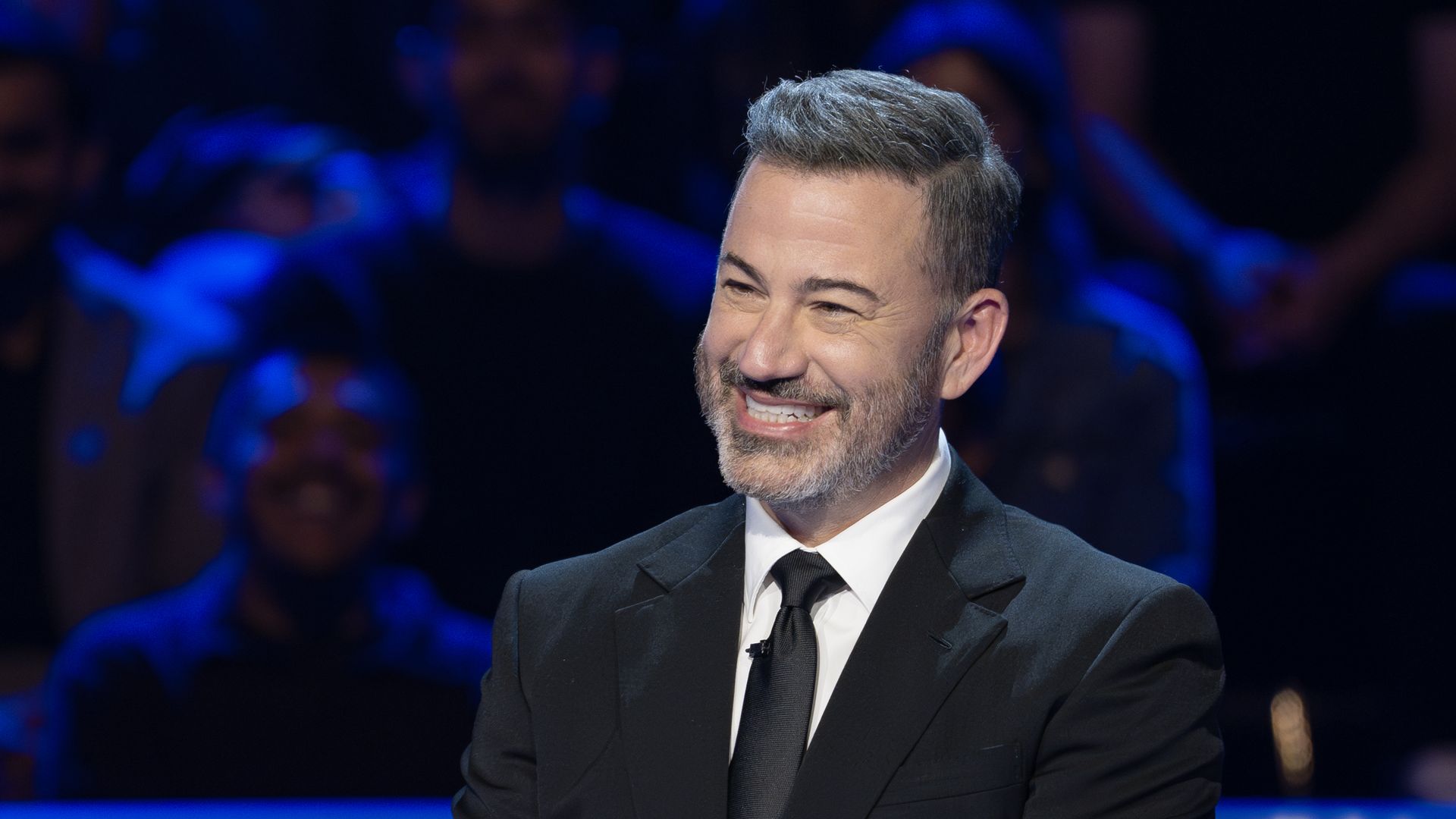 Jimmy Kimmel smiles while hosting "Who Wants to Be A Millionaire" in June.