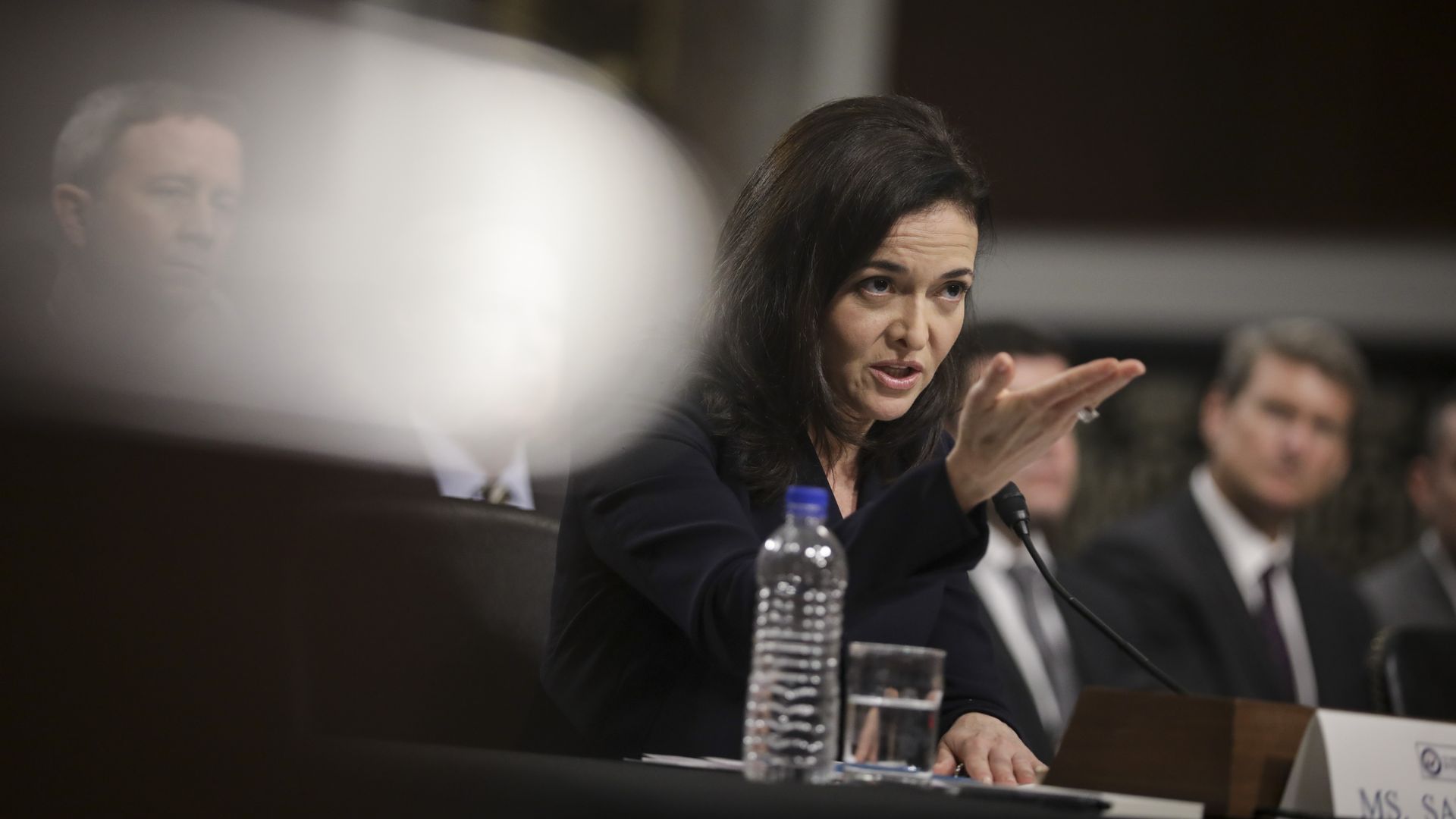 Sheryl Sandberg gestures while testifying