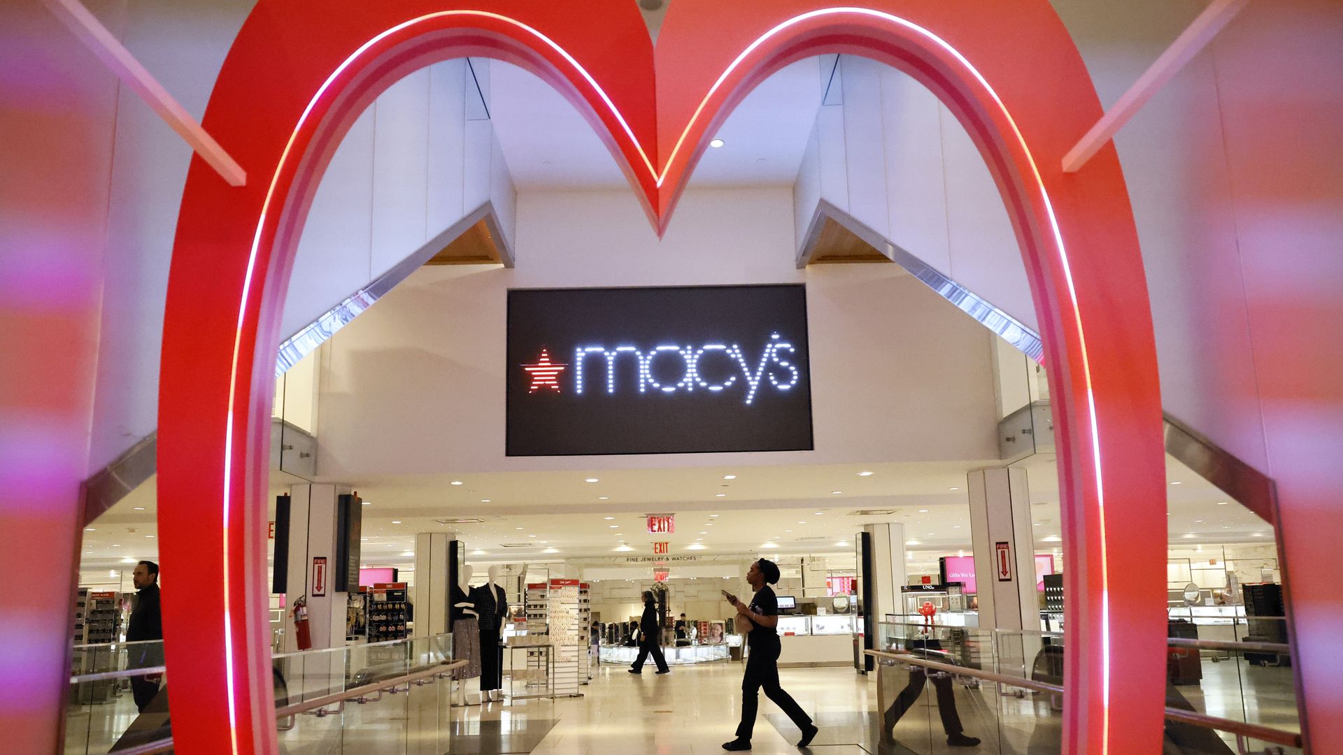 A Macy's sign viewed through a heart-shaped arch.