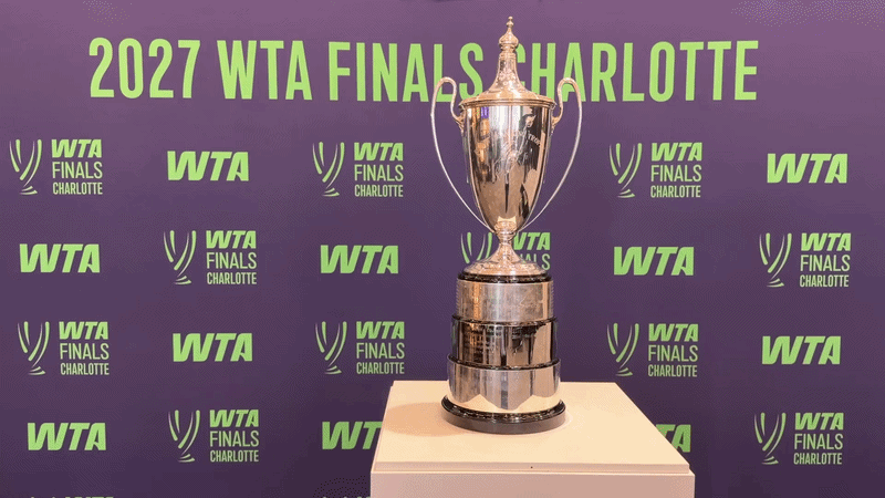 WTA Finals trophy in front of a sign reading "2027 WTA FINALS CHARLOTTE."