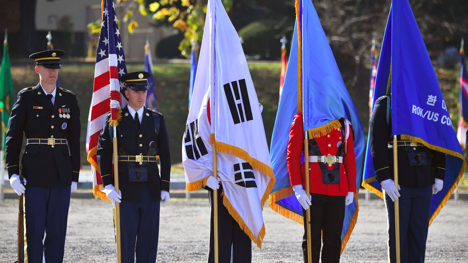  United Nations Command honour guards hold flags during a repatriation ceremony for the remains of an unidentified Korean War UN forces soldier at a US Army base in Seoul on November 20, 2018.