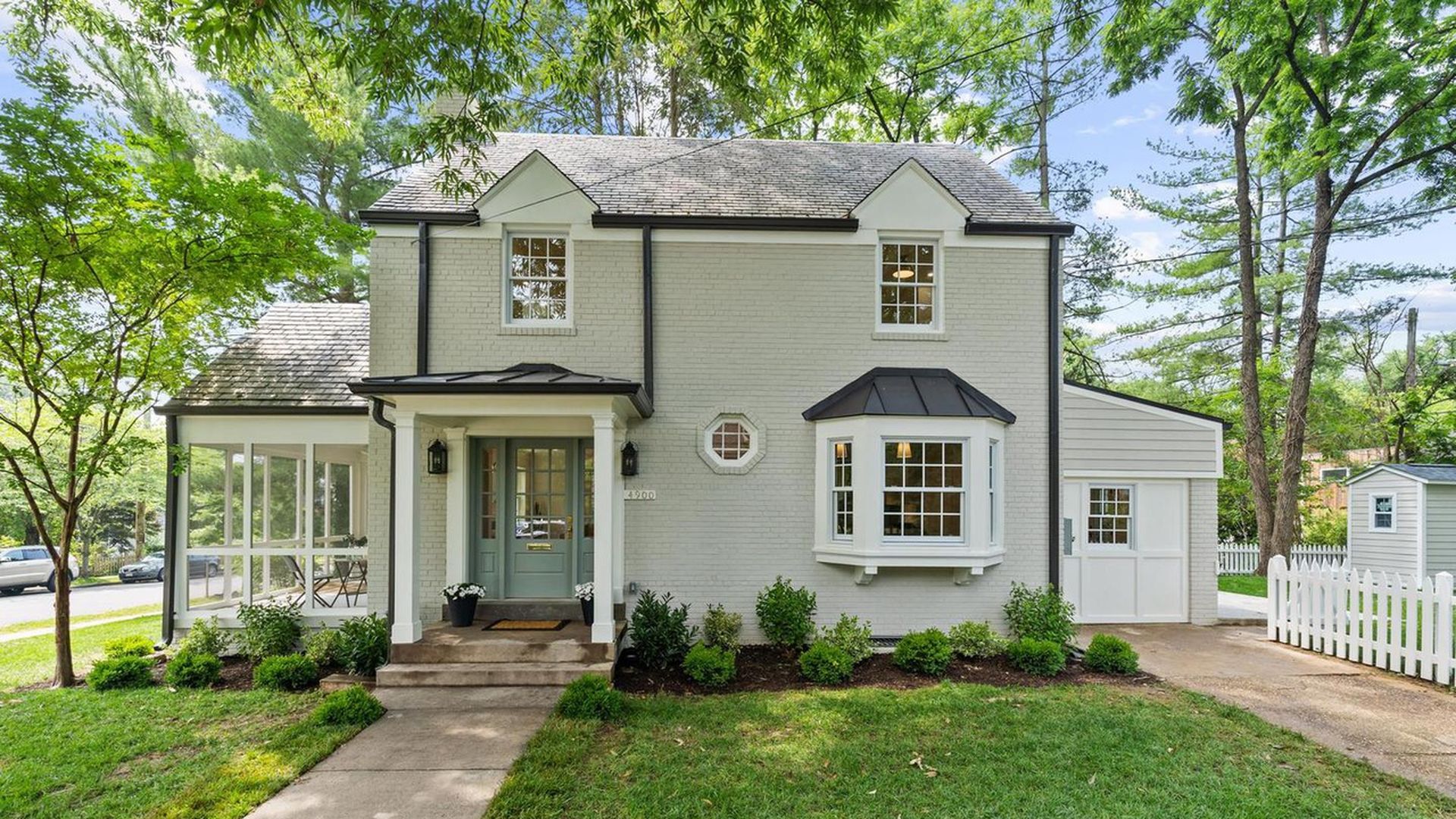 Two story house with walkway and fenced yard at 4900 Chesapeake St. NW.