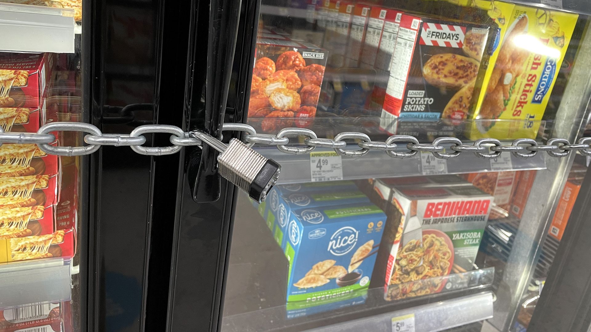 Photo of a lock chain wrapped around a freezer section in a grocery store