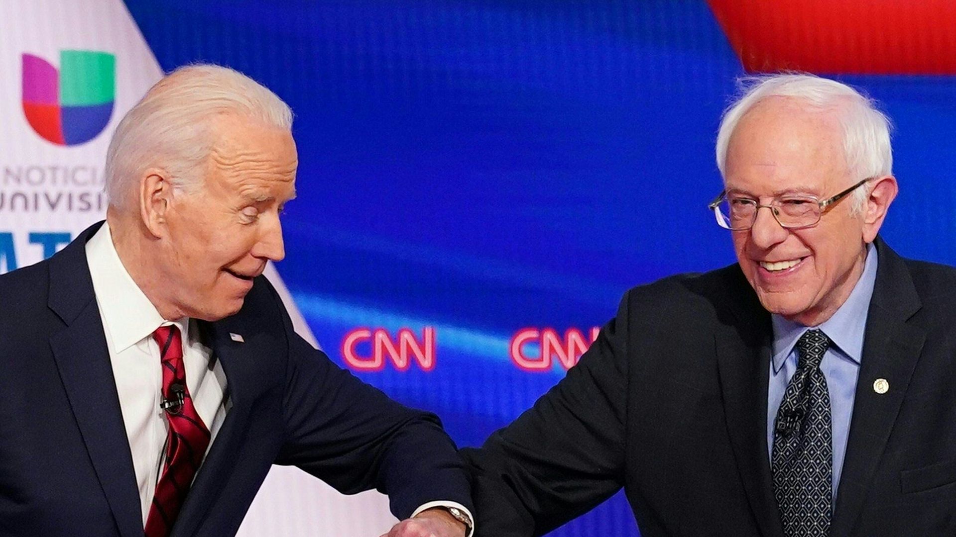 Biden and Sanders bump elbows on the debate stage last month