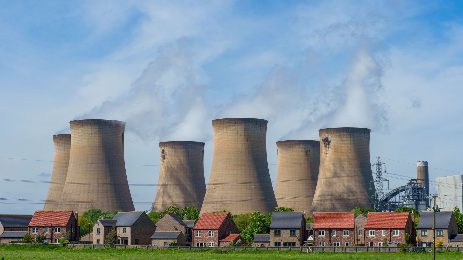 The Drax Power Station in the UK, with cooling towers emitting steam.