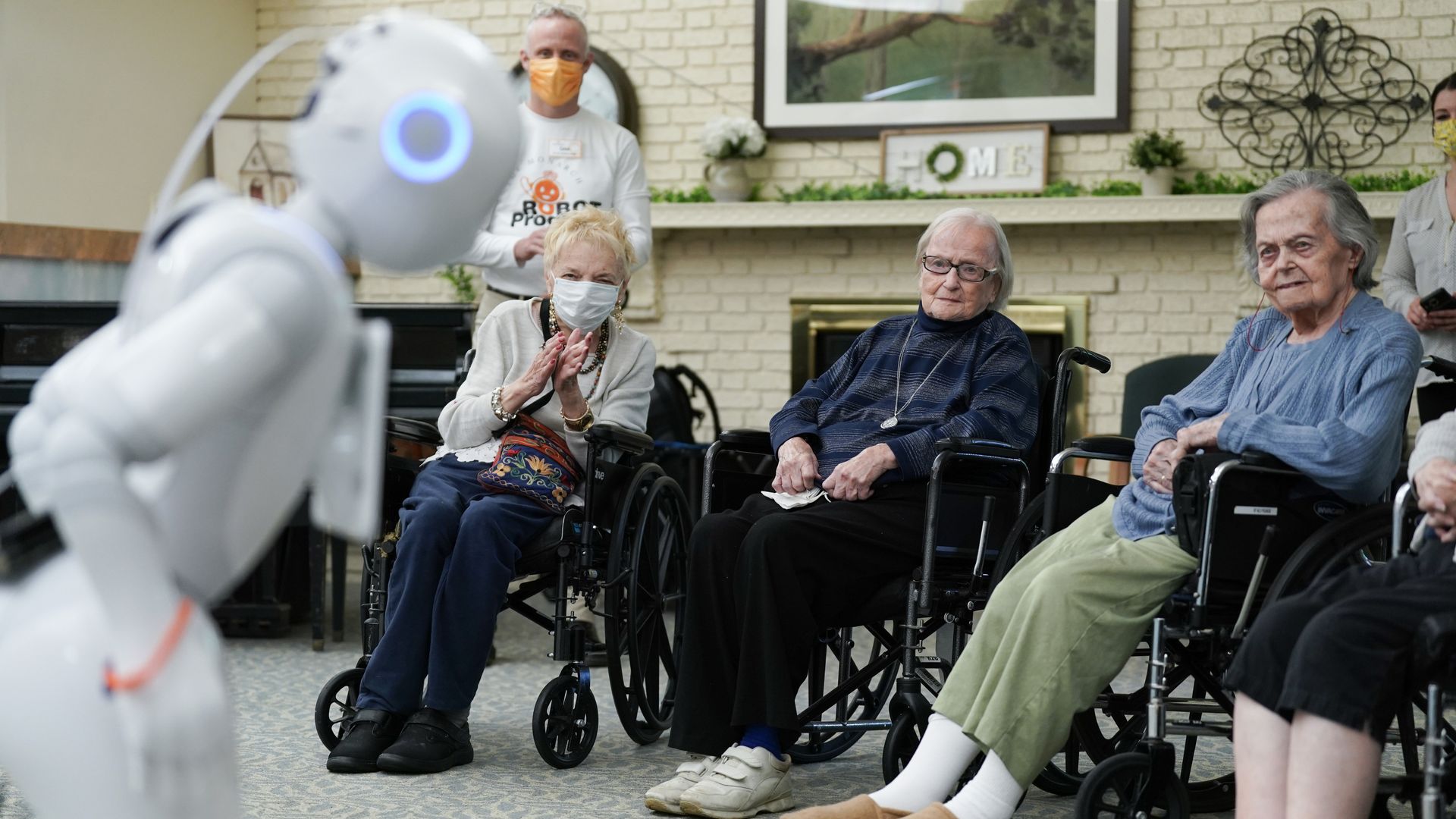 A humanoid robot entertains residents of a nursing home.