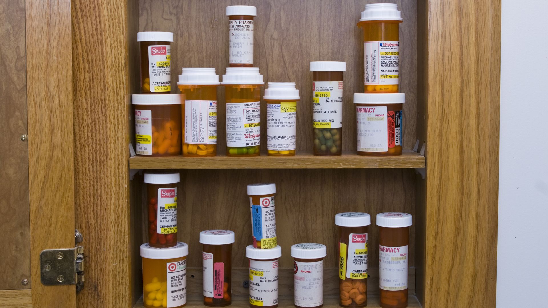 A medicine cabinet full of prescription bottles.