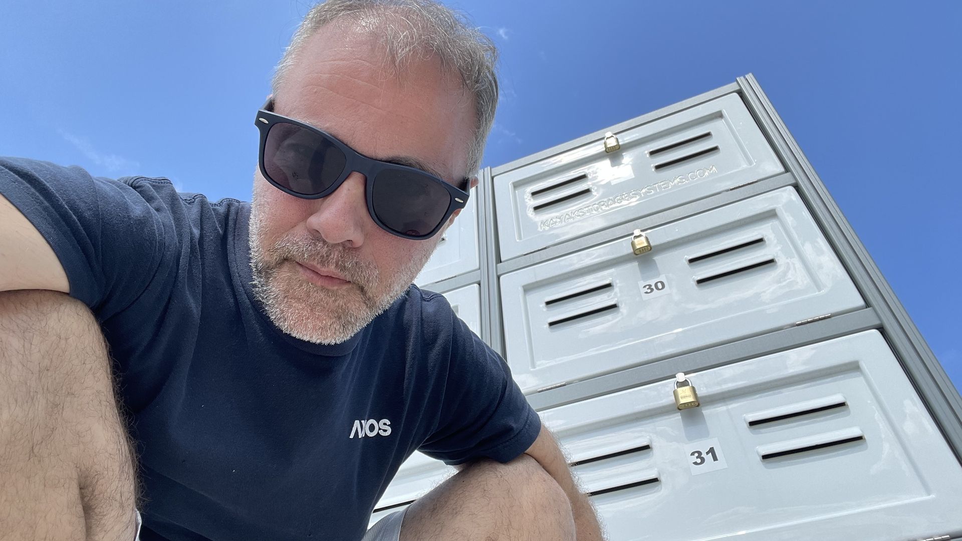 Jason in front of canoe lockers