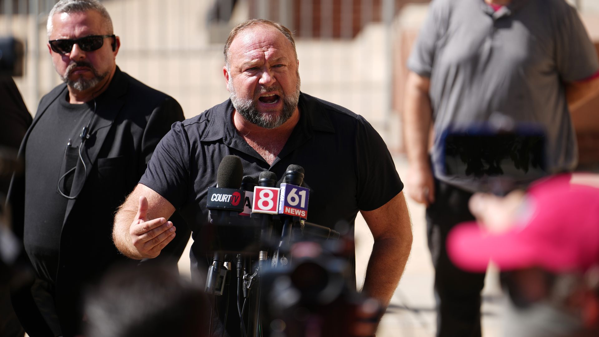 InfoWars founder Alex Jones speaks to the media outside Waterbury Superior Court in Waterbury, Connecticut, in September. 