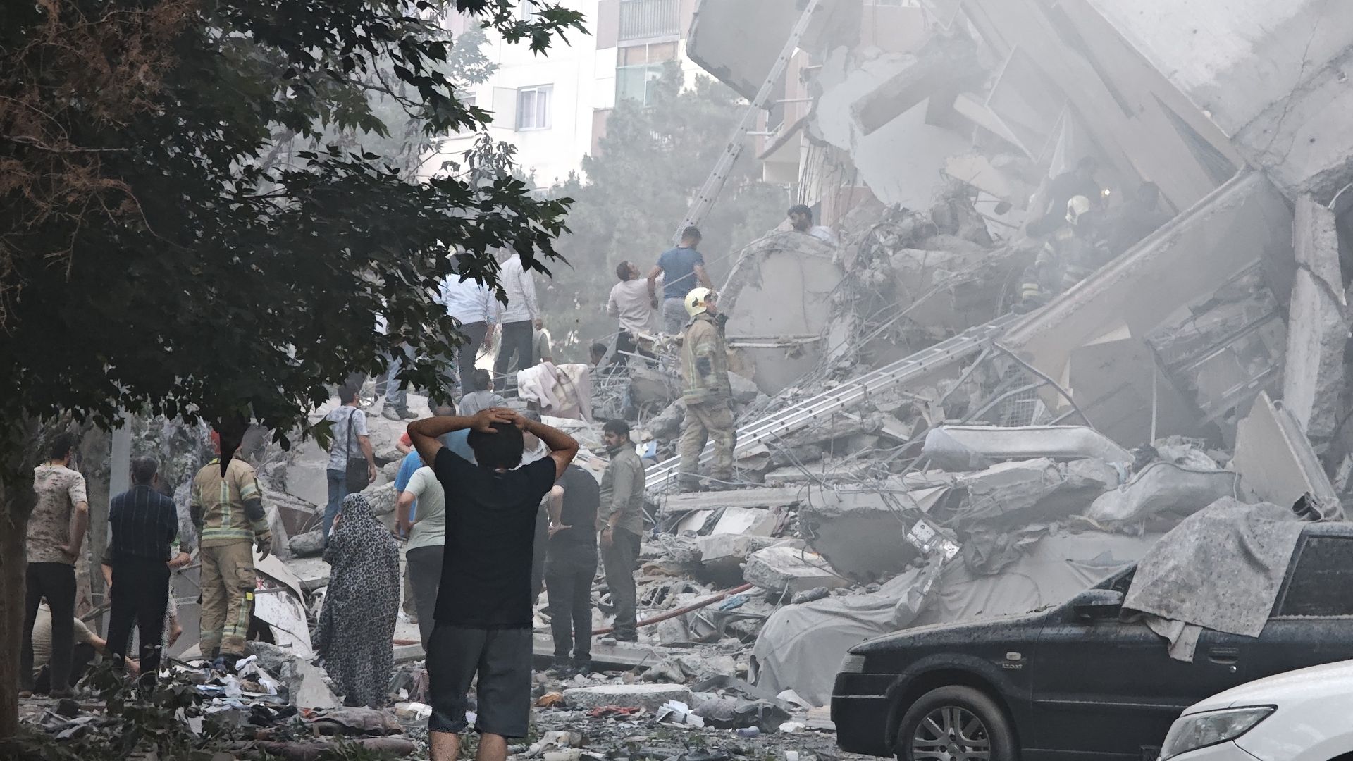 People look over damage to buildings in Nobonyad Square following Israeli airstrikes on June 13, 2025 in Tehran, Iran.