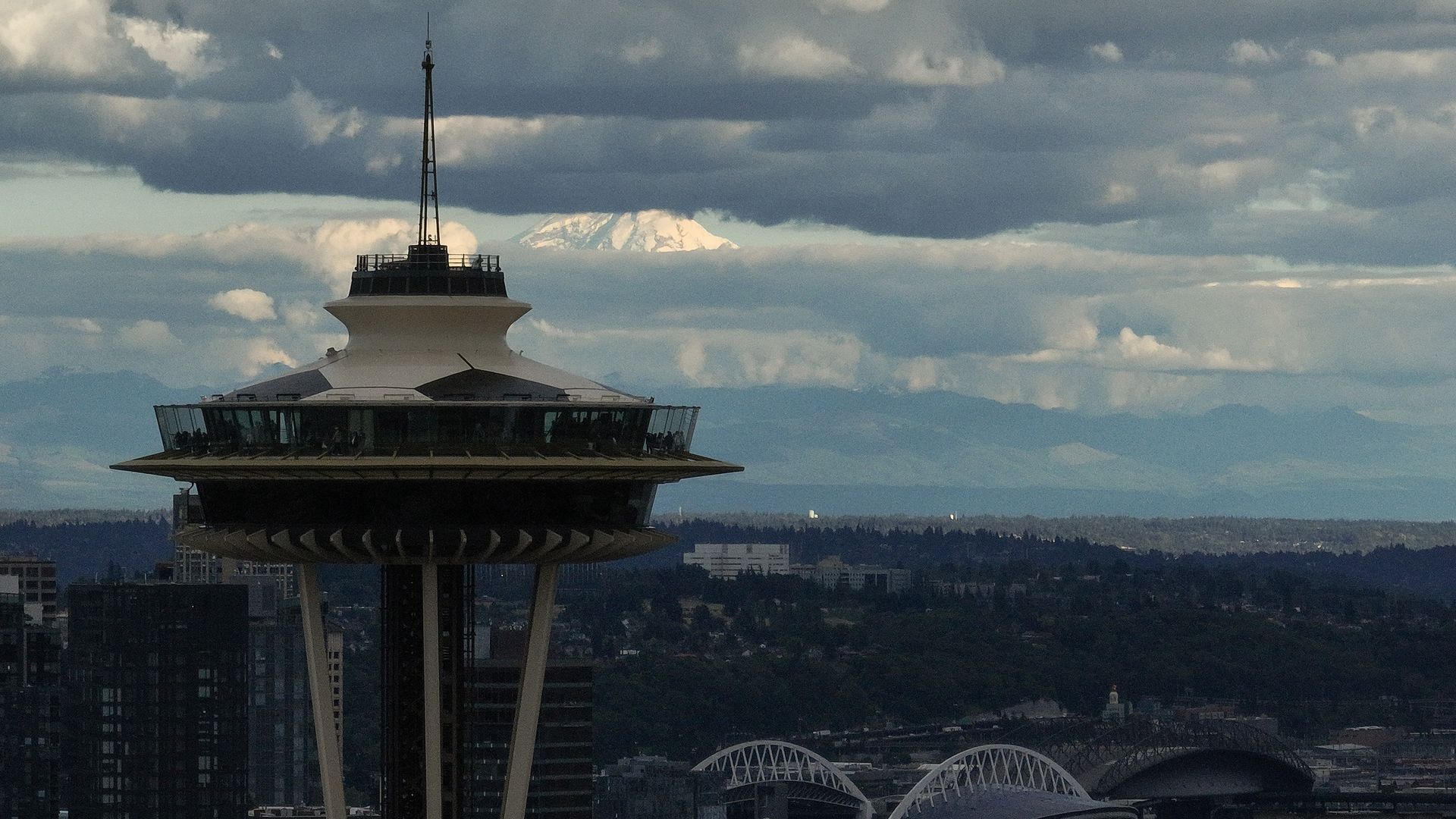 A view of the Space Needle set against a cloudy, gray sky. 