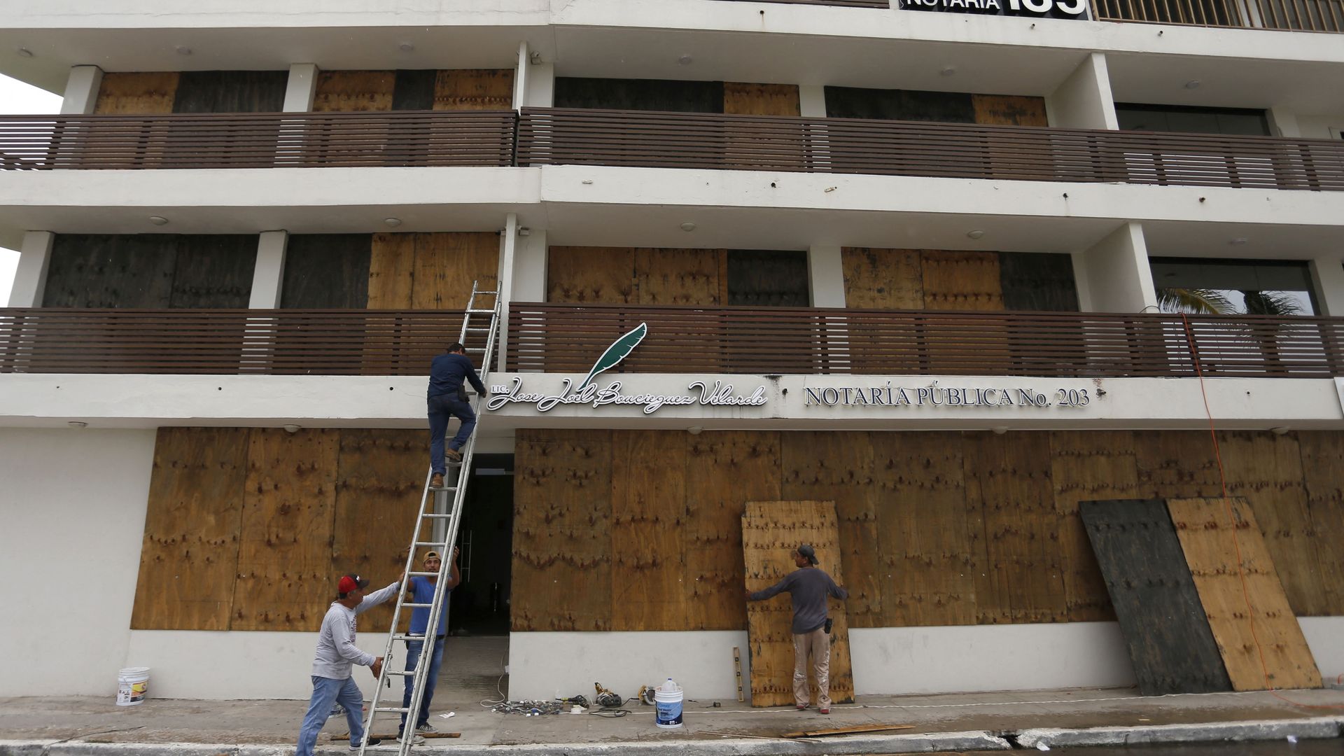 Men board up a seafront building ahead of the arrival of Hurricane Orlene, in Mazatlan, state of Sinaloa, Mexico