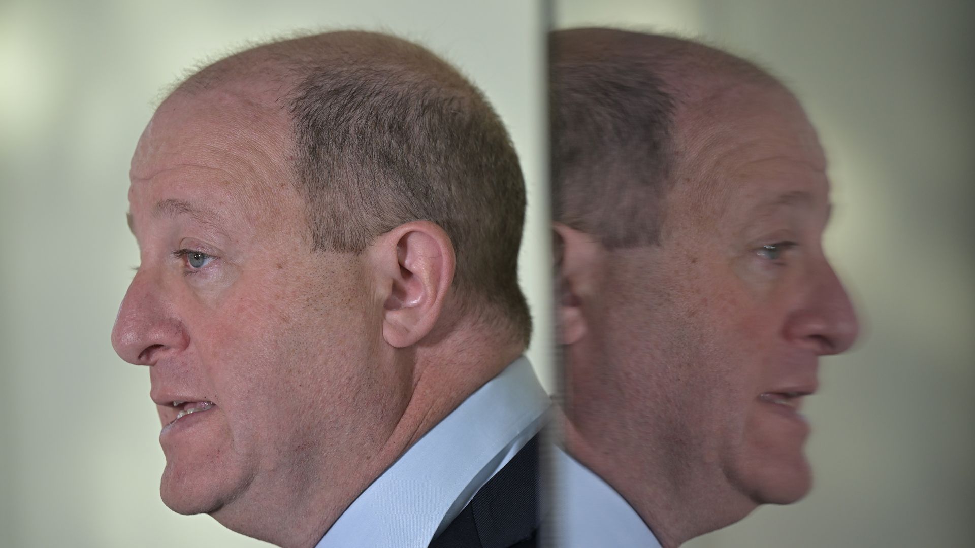 Gov. Jared Polis is reflected in the glass at a press conference at the governor's residence in 2025. Photo: Hyoung Chang/The Denver Post via Getty Images