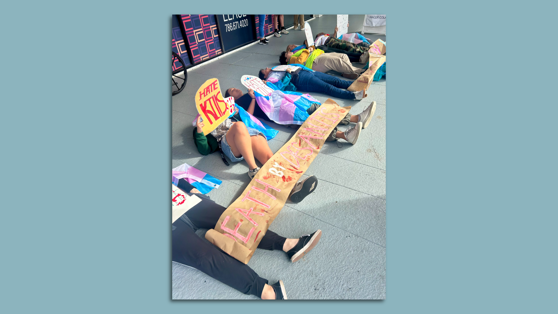 Protesters stage a "die-in" by lying on the sidewalk.