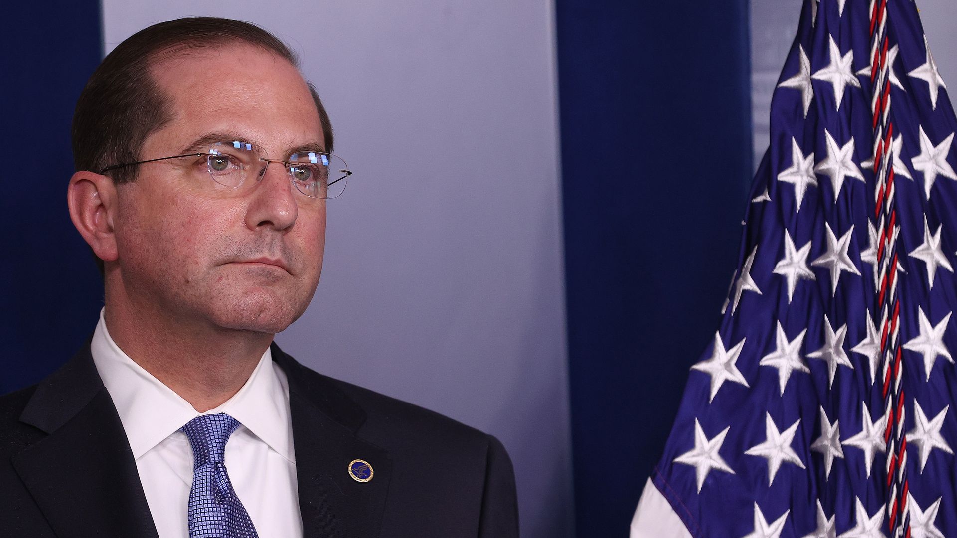 HHS Secretary Alex Azar stands in the White House press briefing room