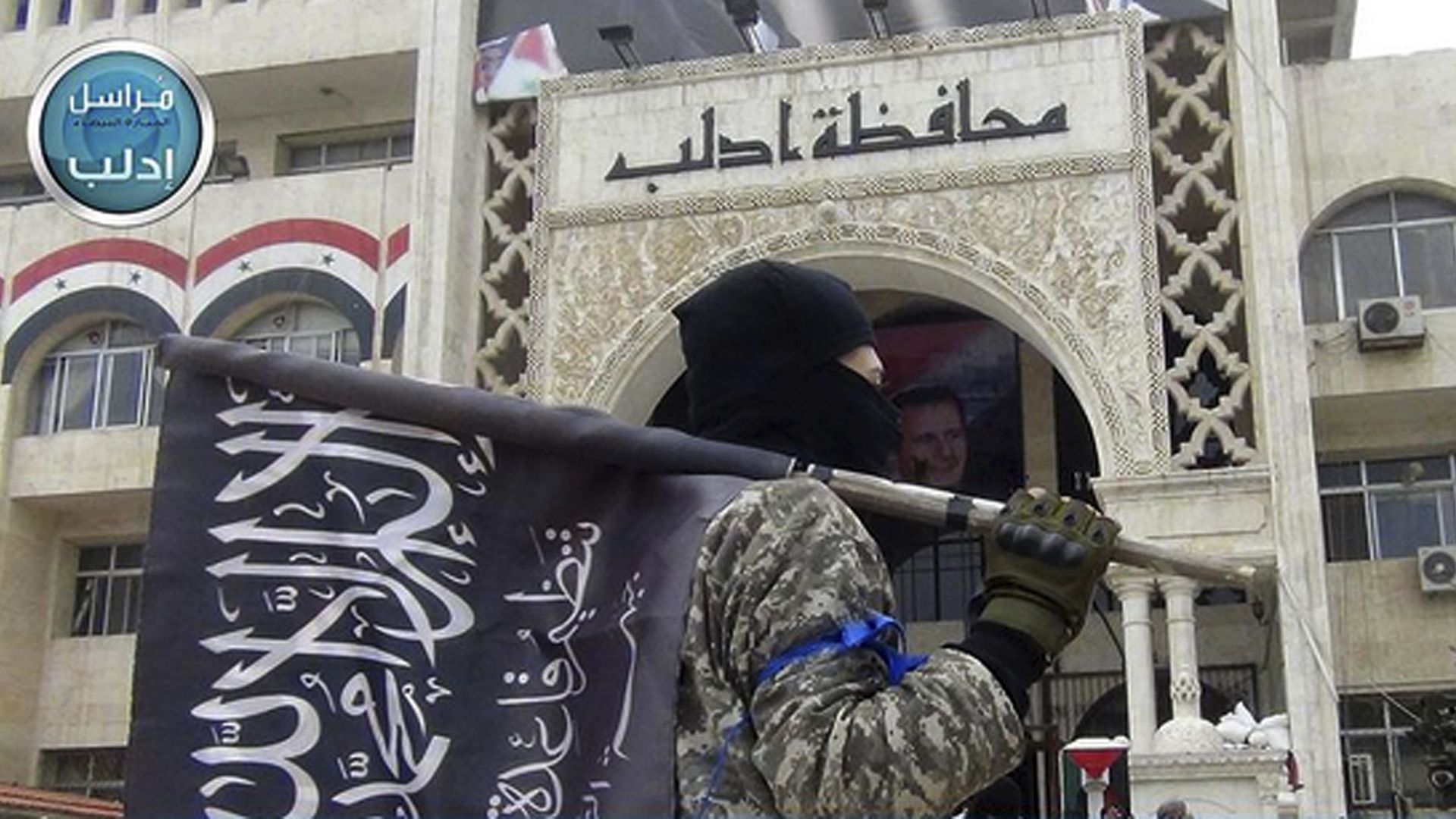 Masked al-Nusra fighter with flag