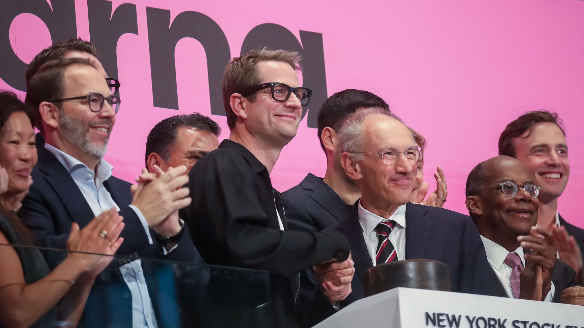 People gathered on the stage of the New York Stock exchange,