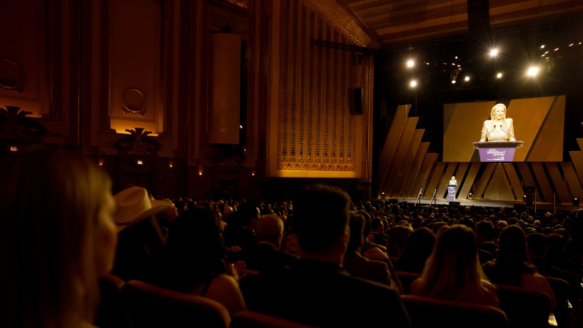 A view of a stage taken from a crowd. 