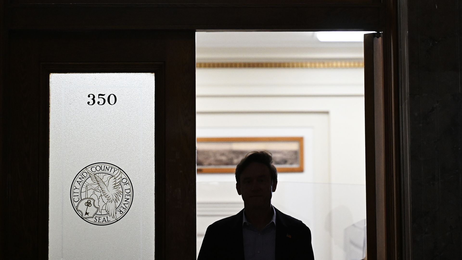 A man's silhouette against a door with the words MAYOR MIKE JOHNSTON.  