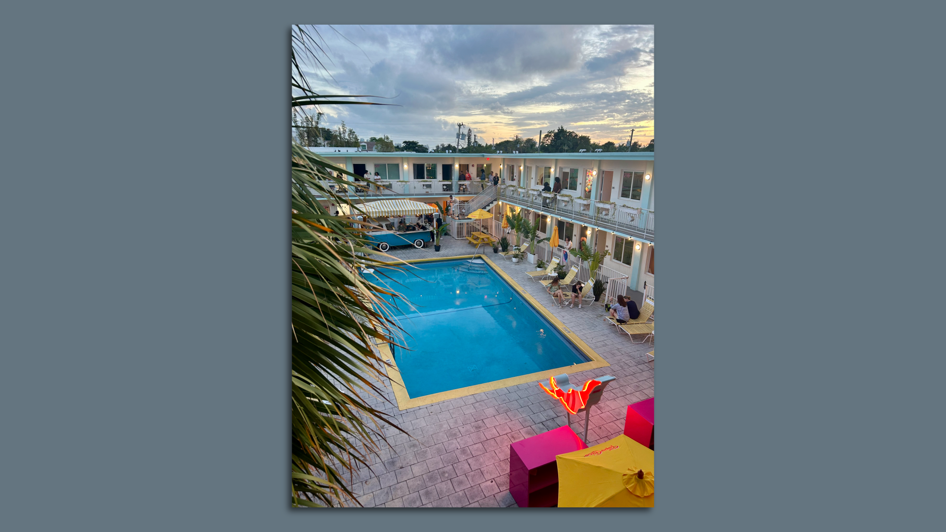 People sitting around a pool during Art Basel. 