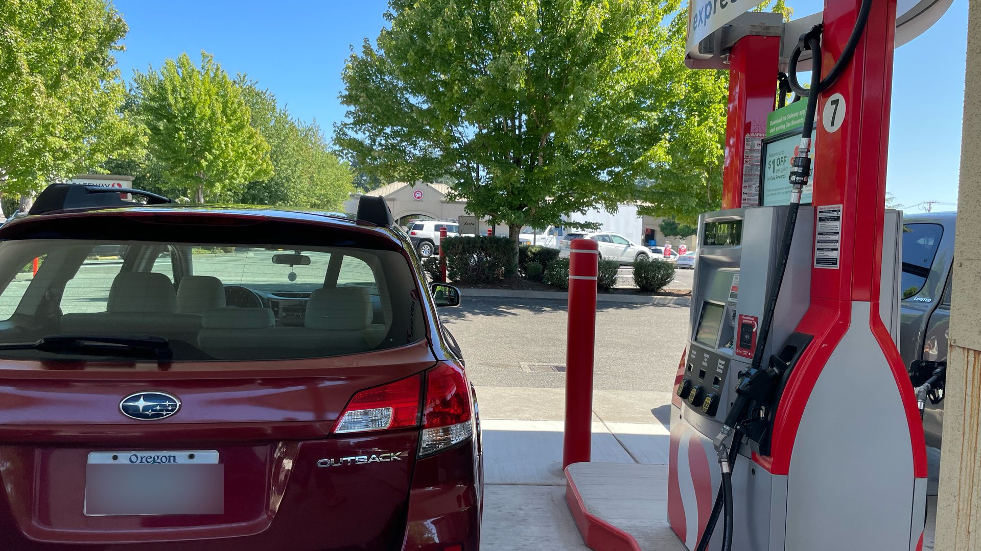 An image of a car next to a gas pump.
