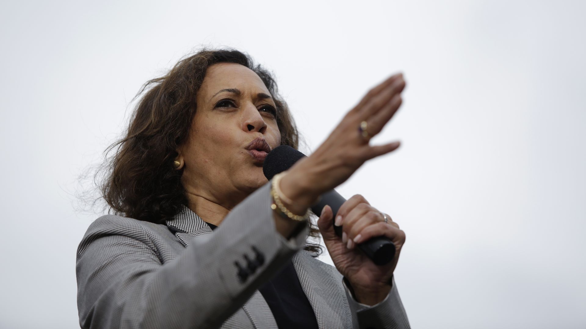 In this image, Harris speaks into a microphone.