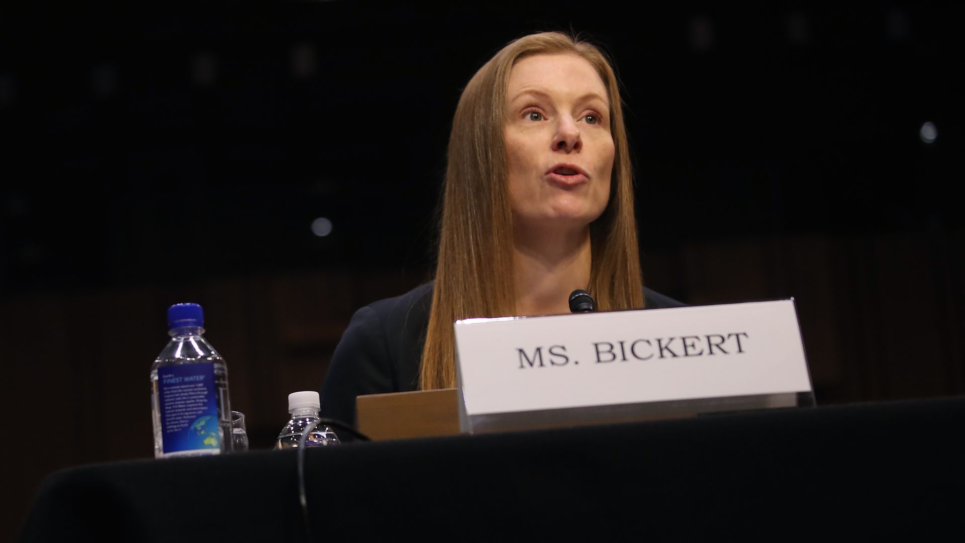 A photo of Facebook's Monika Bickert testifying at a table with a name plate in front of her.