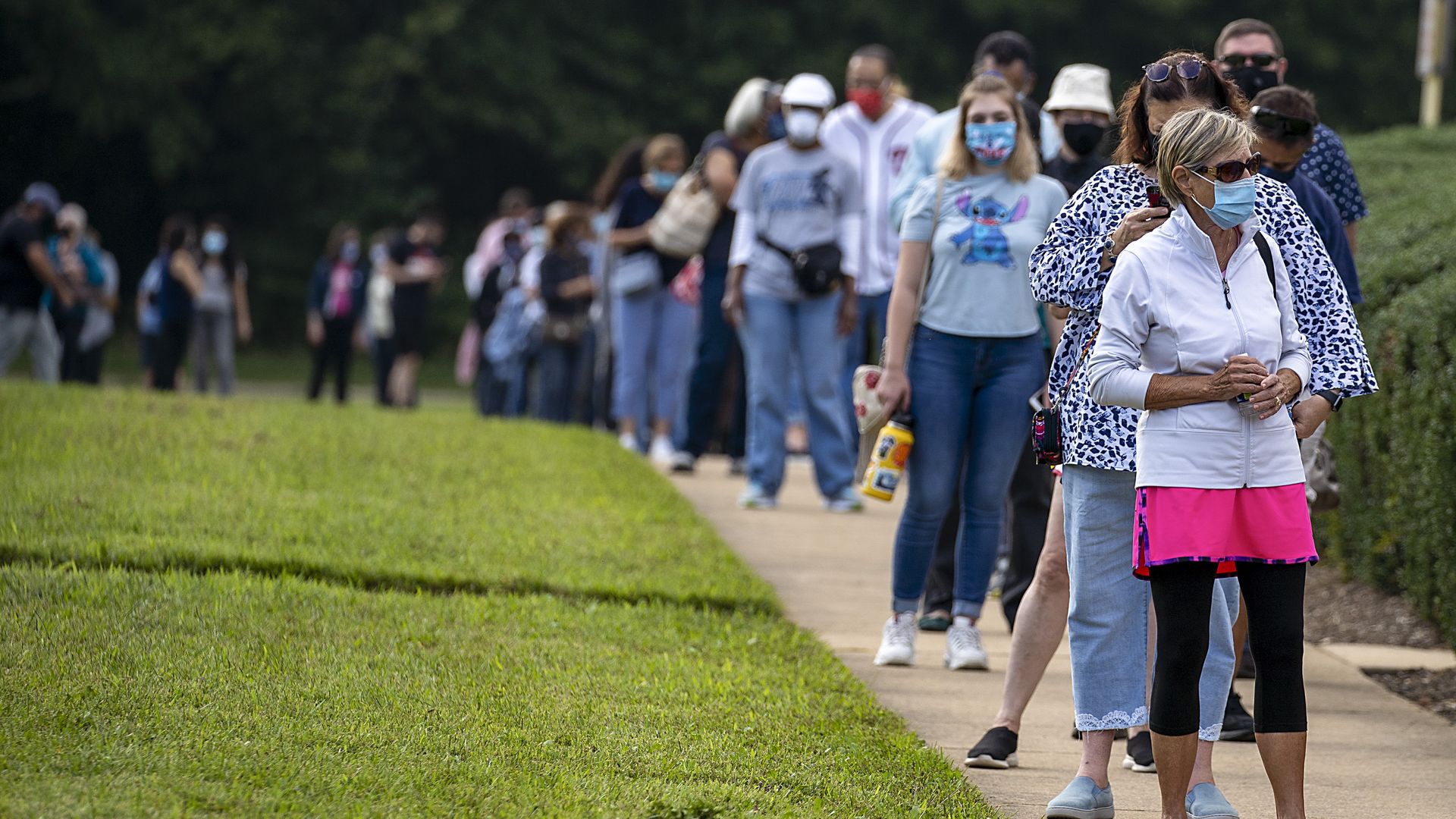  People stand on line, spaced six apart due to COVID-19, in order to vote early at the Fairfax Government Center on September 18, 2020 in Fairfax, Virginia.
