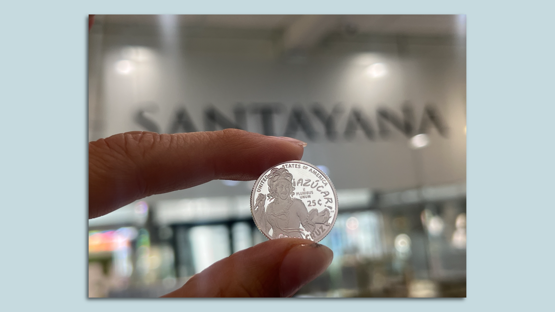 Two fingers holding a coin. 