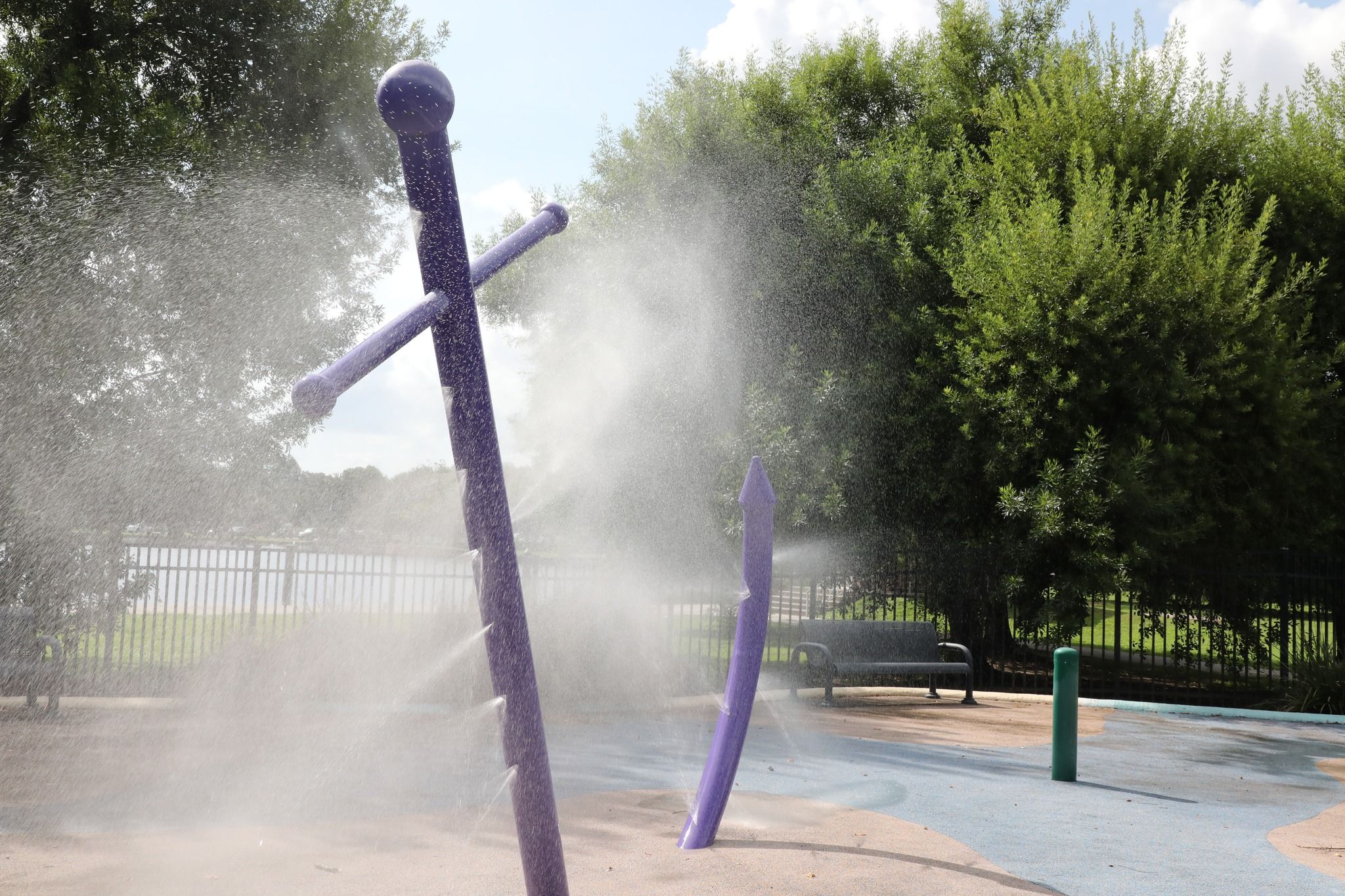 Photo shows water features that spray water.