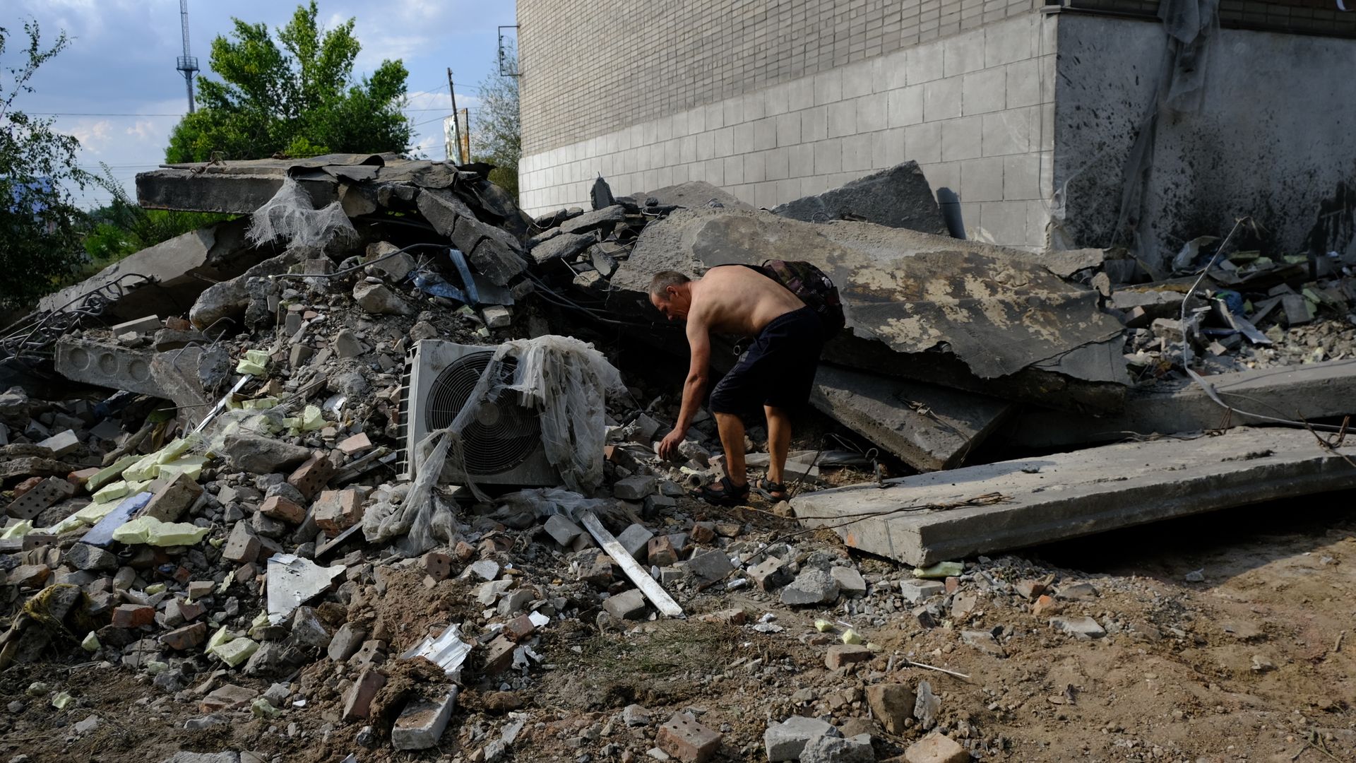Local residents search for their belongings amid rubbles of a building damaged in an attack by Russian forces on the city of Toretsk in the Donetsk Oblast, Ukraine on July 28, 2022.
