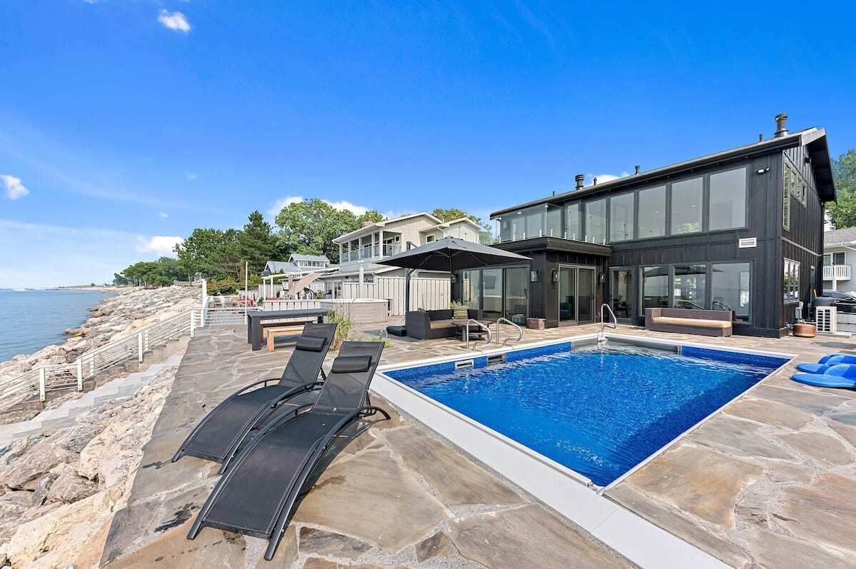 Photo of a pool and back of a house. 