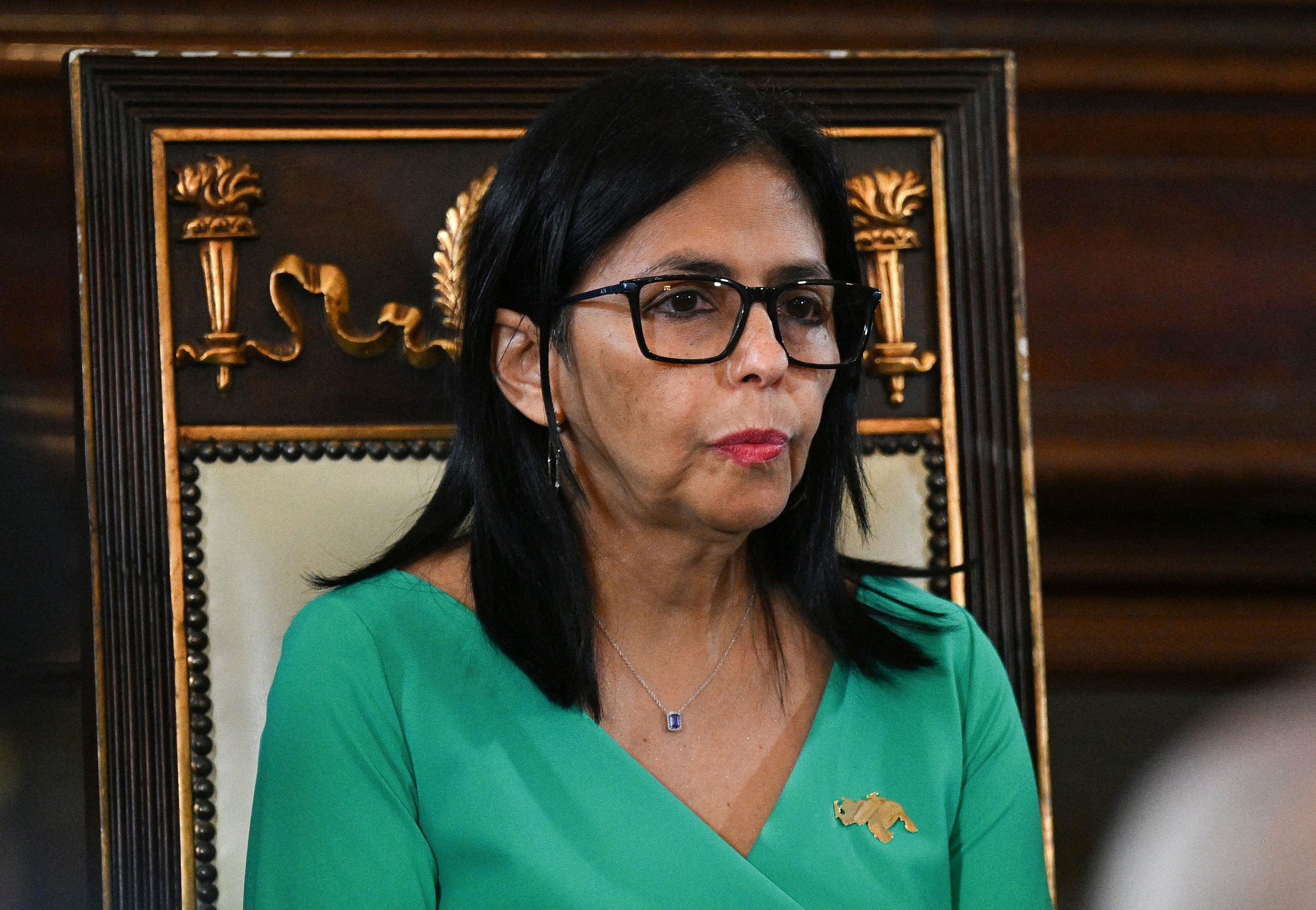 Delcy Rodríguez raising her right hand while taking the oath of office as interim president before lawmakers at the National Assembly in Caracas, Venezuela.