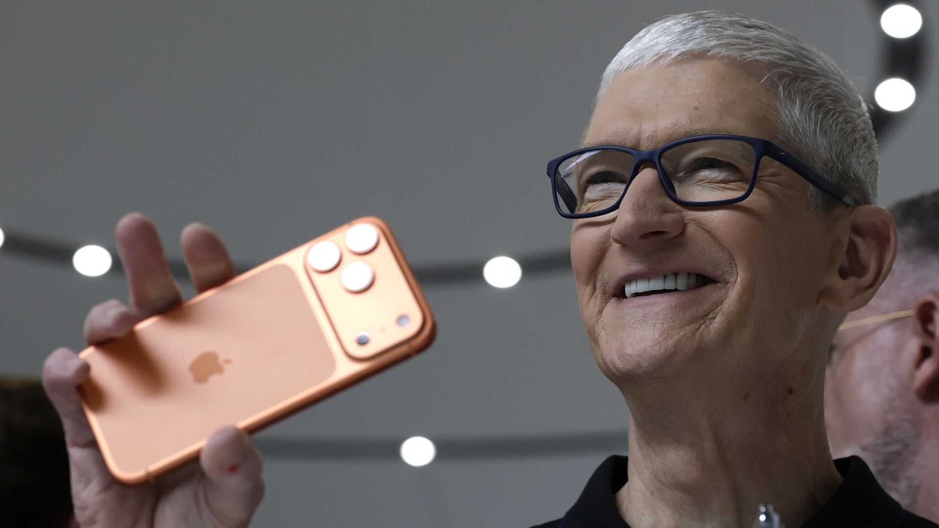 Apple CEO Tim Cook holds up the  iPhone 17 Pro at its September launch event. 