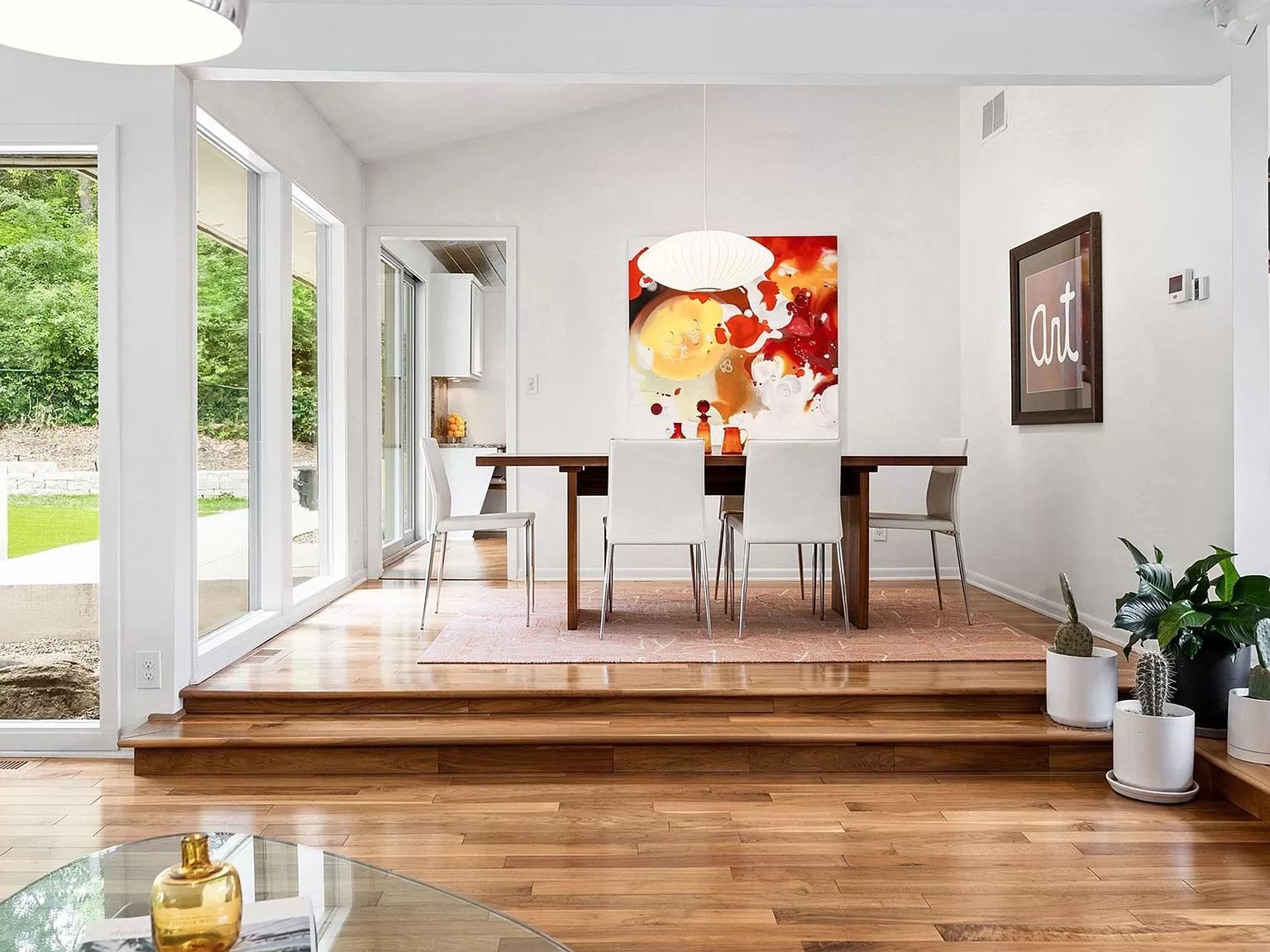 A dining room with a table and chairs.