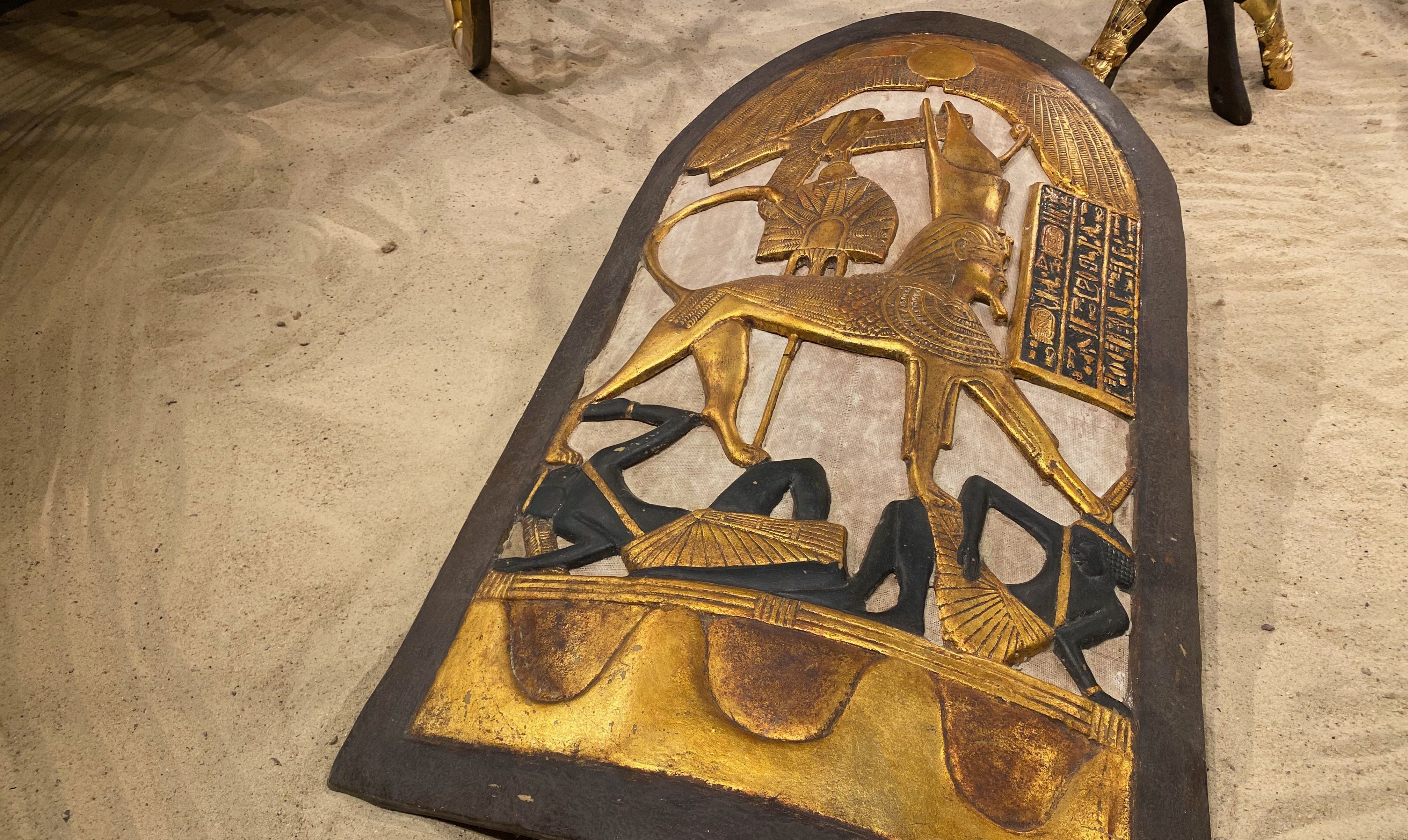 A shield depicting Tutankhamun as a golden sphinx