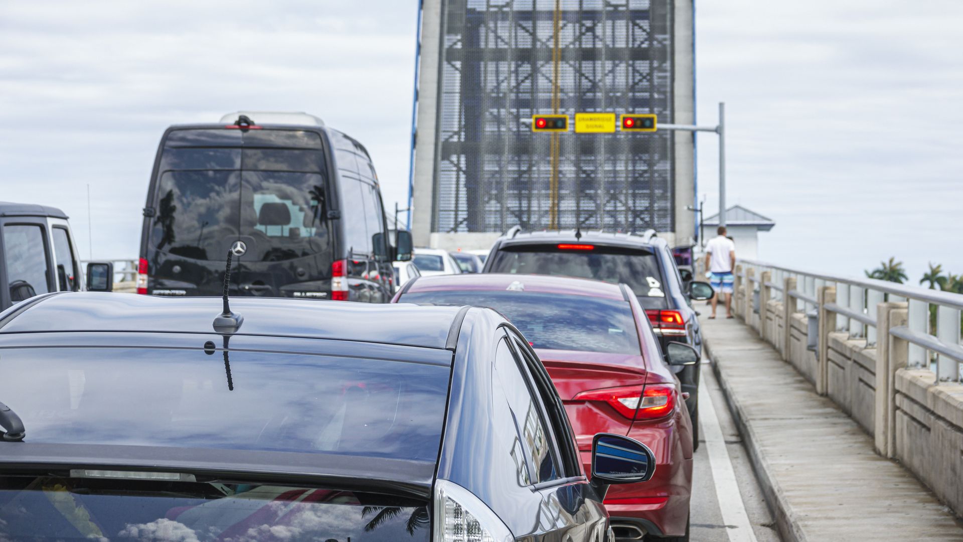 Traffic is backed up while a drawbridge is up.