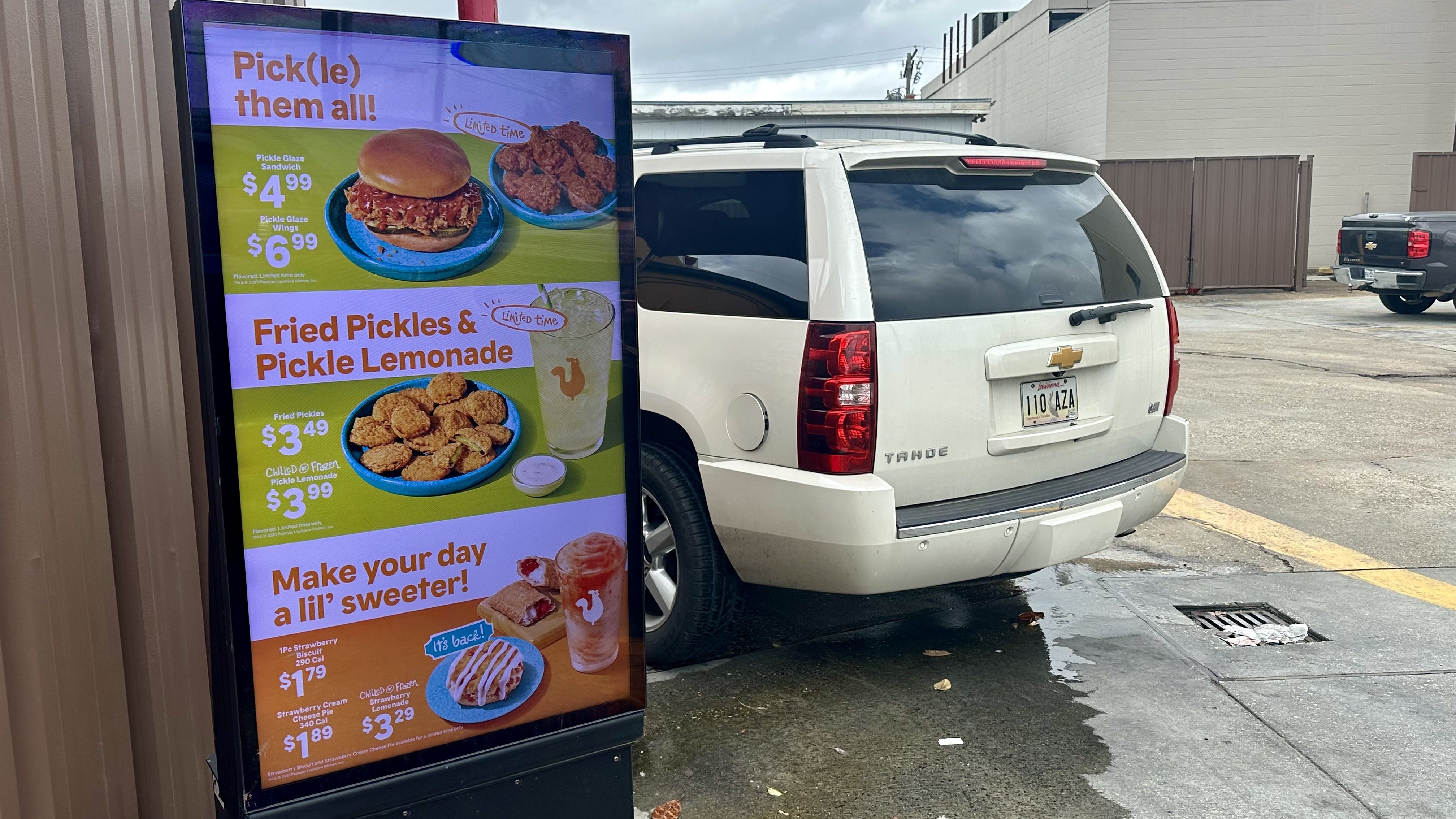 Photo shows a drive-thru sign with pickles on the menu.