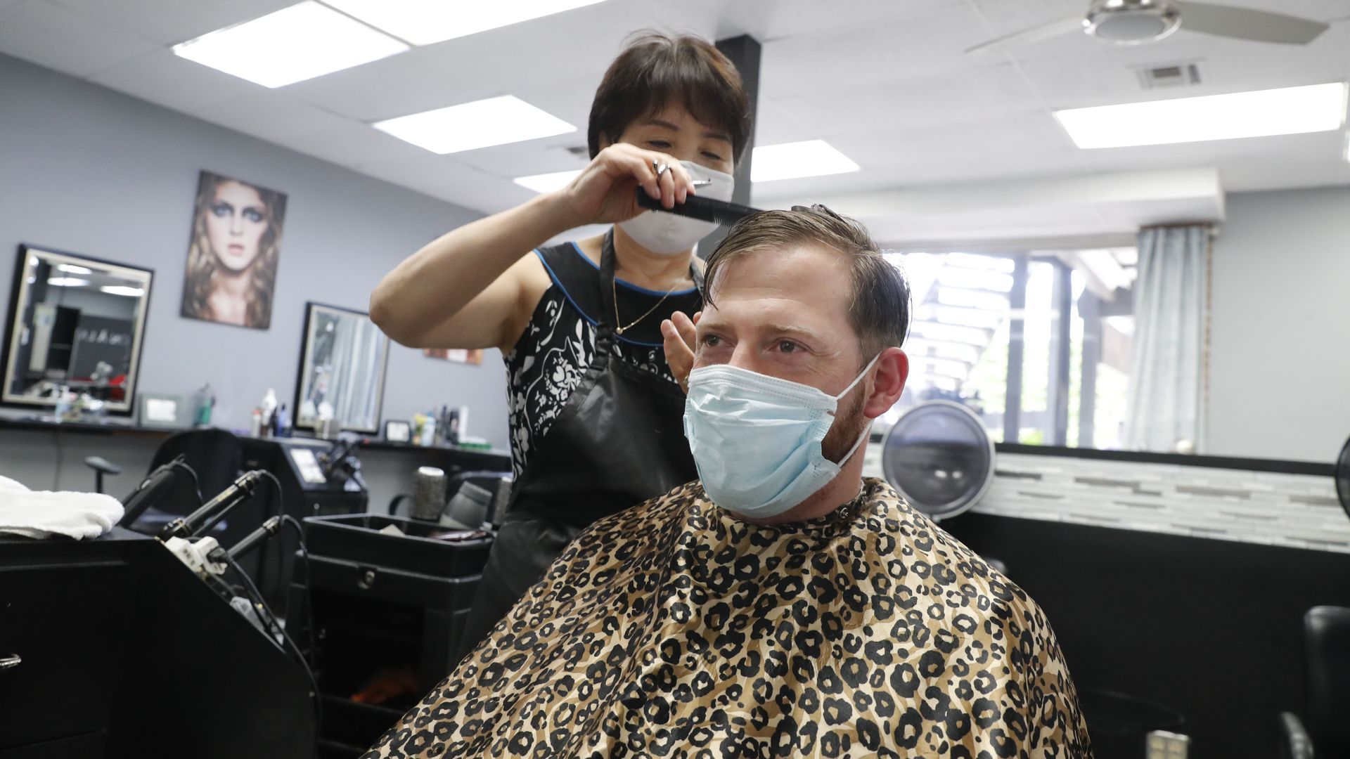 Joe Farley wears a mask as he gets a haircut at the just reopened Salon À la Mode in Dallas