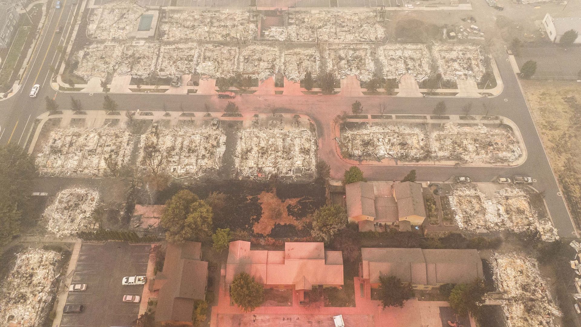 In this aerial view from a drone, structures destroyed by wildfire and others spared by fire retardant are seen on September 12, 2020 in Talent, Oregon.