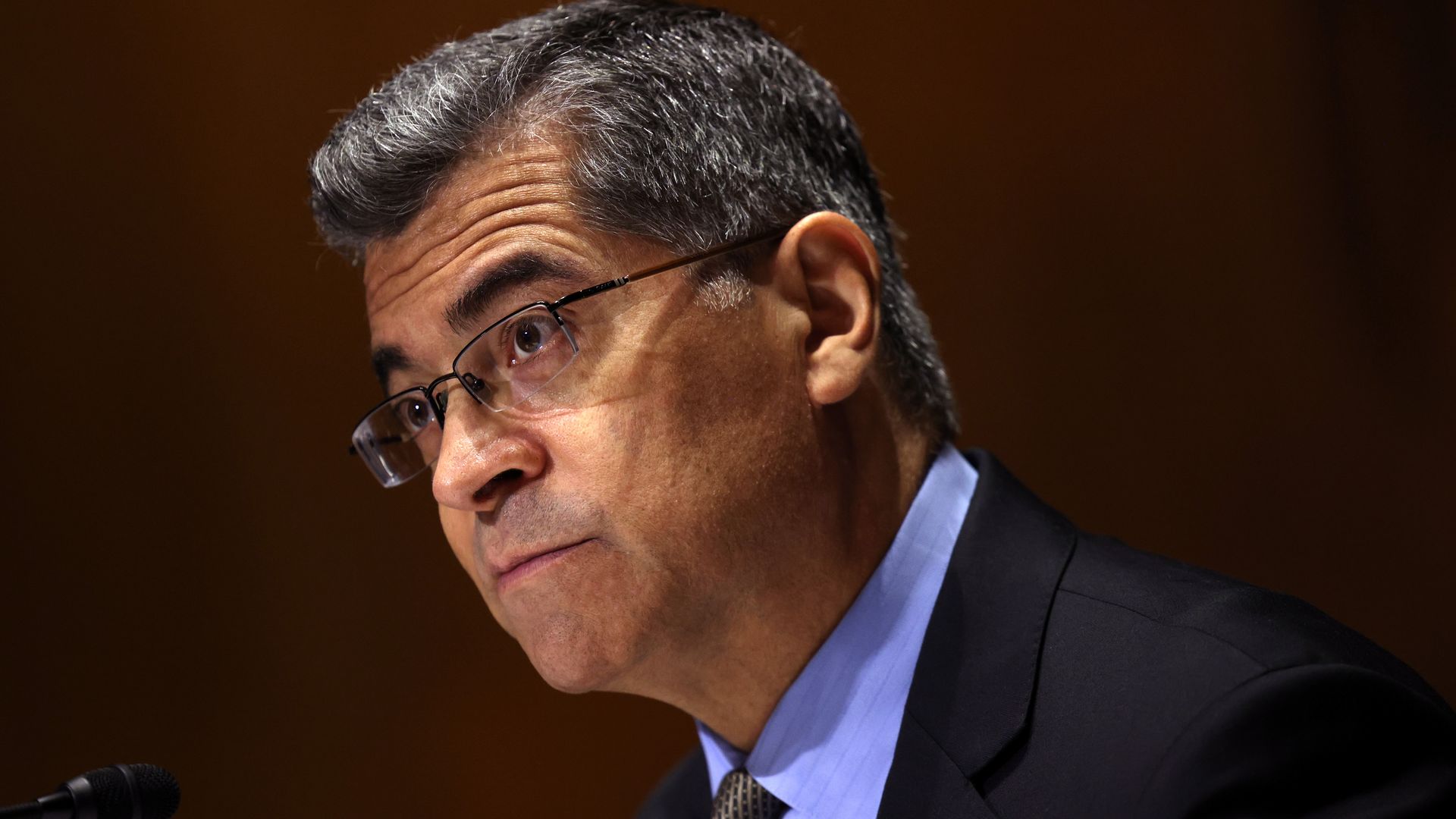 Photo of Xavier Becerra in a suit and glasses from the shoulders up