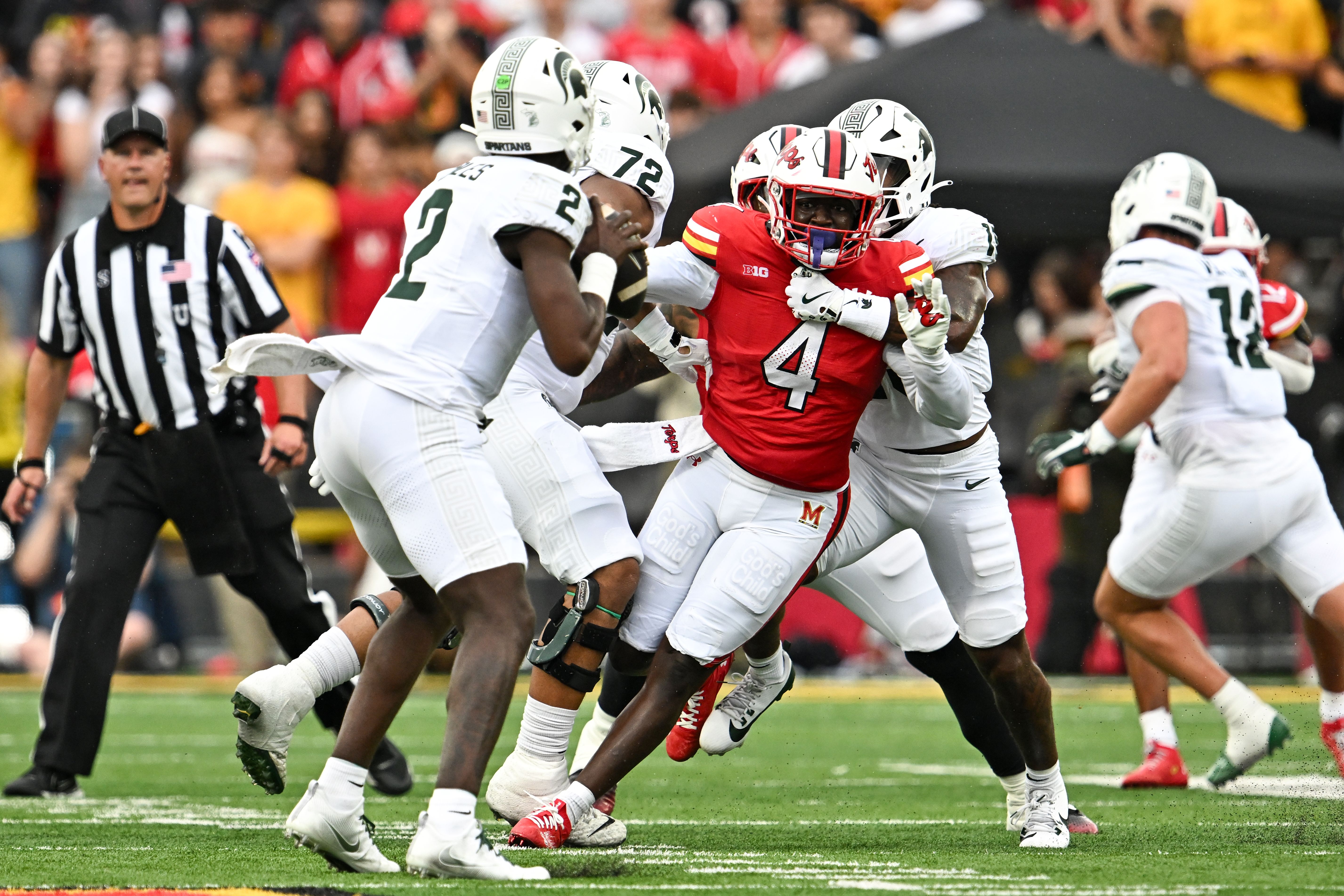Photo of a football player rushing the quarterback during a game. 