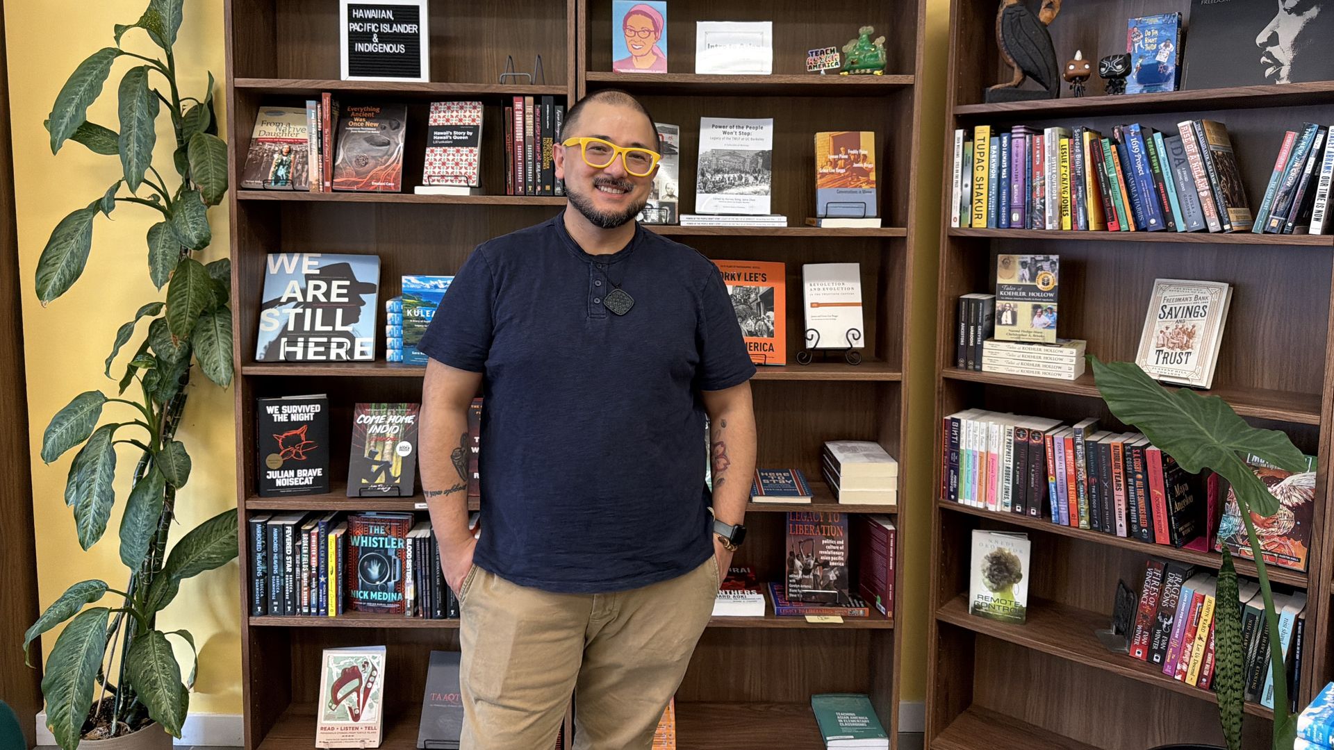 man in front of book shelves