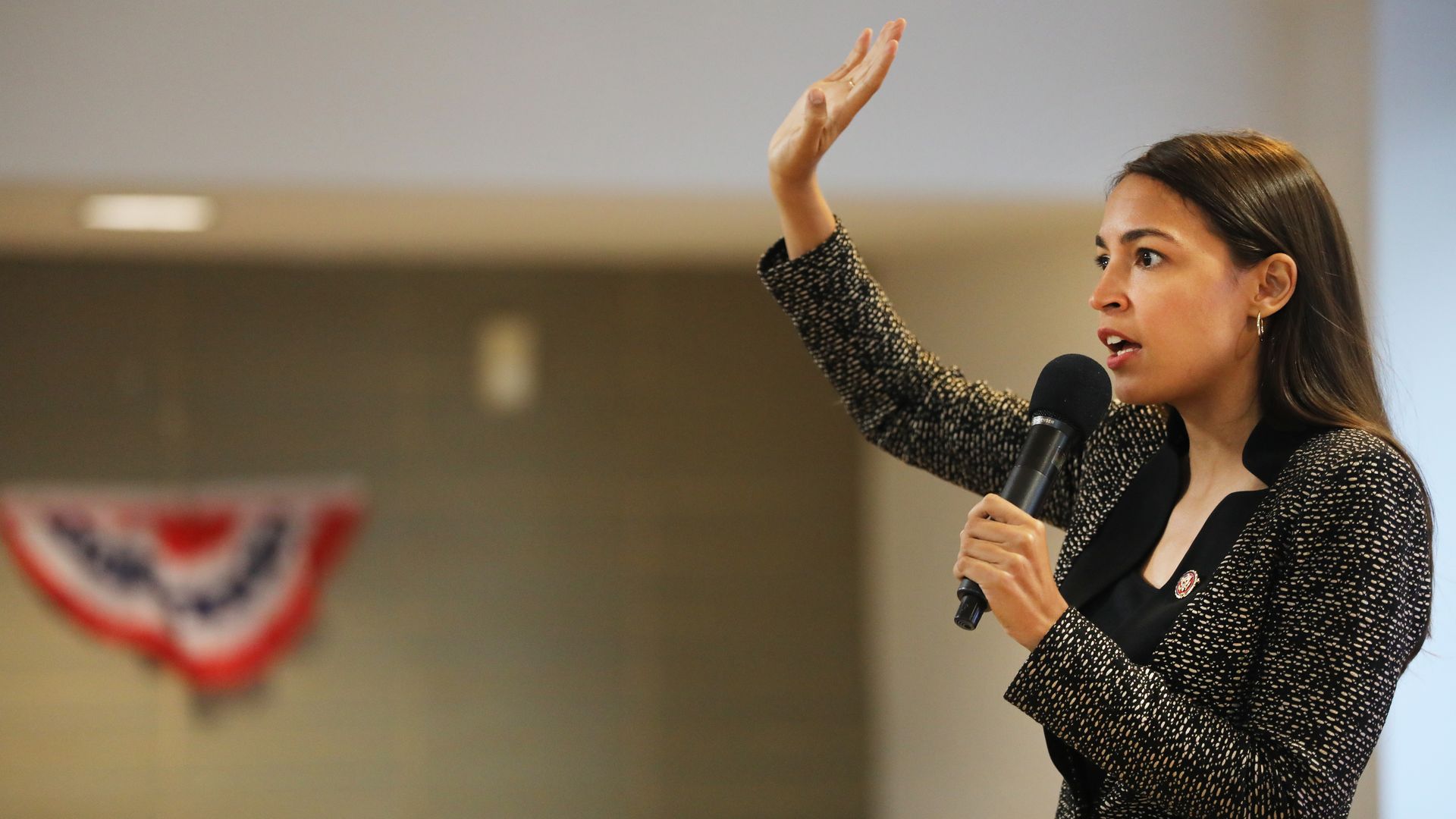 AOC raising her hand.