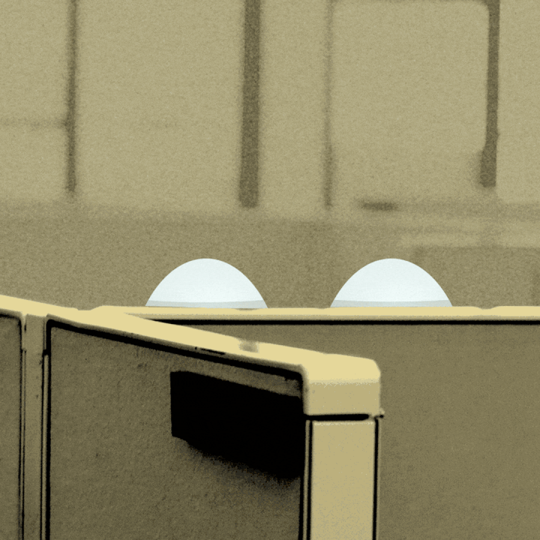 Illustration of a shaking eyes emoji rising from behind a cubicle wall.