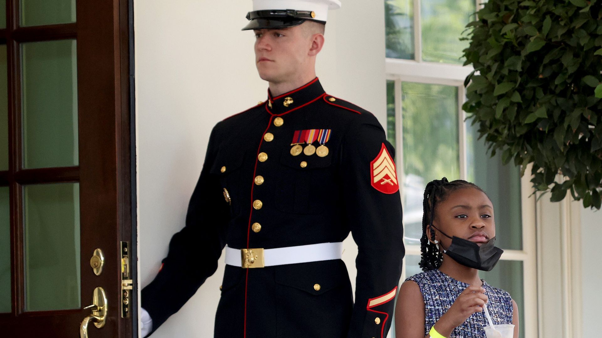 George Floyd's daughter is seen walking out the door to the West Wing of the White House.