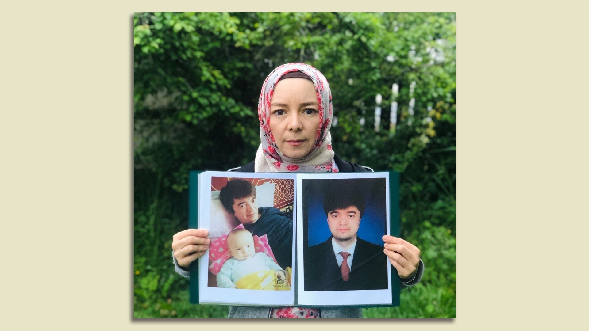 Rizwangul NurMuhammad holds up a photo of her brother, who has been detained in China since 2017.