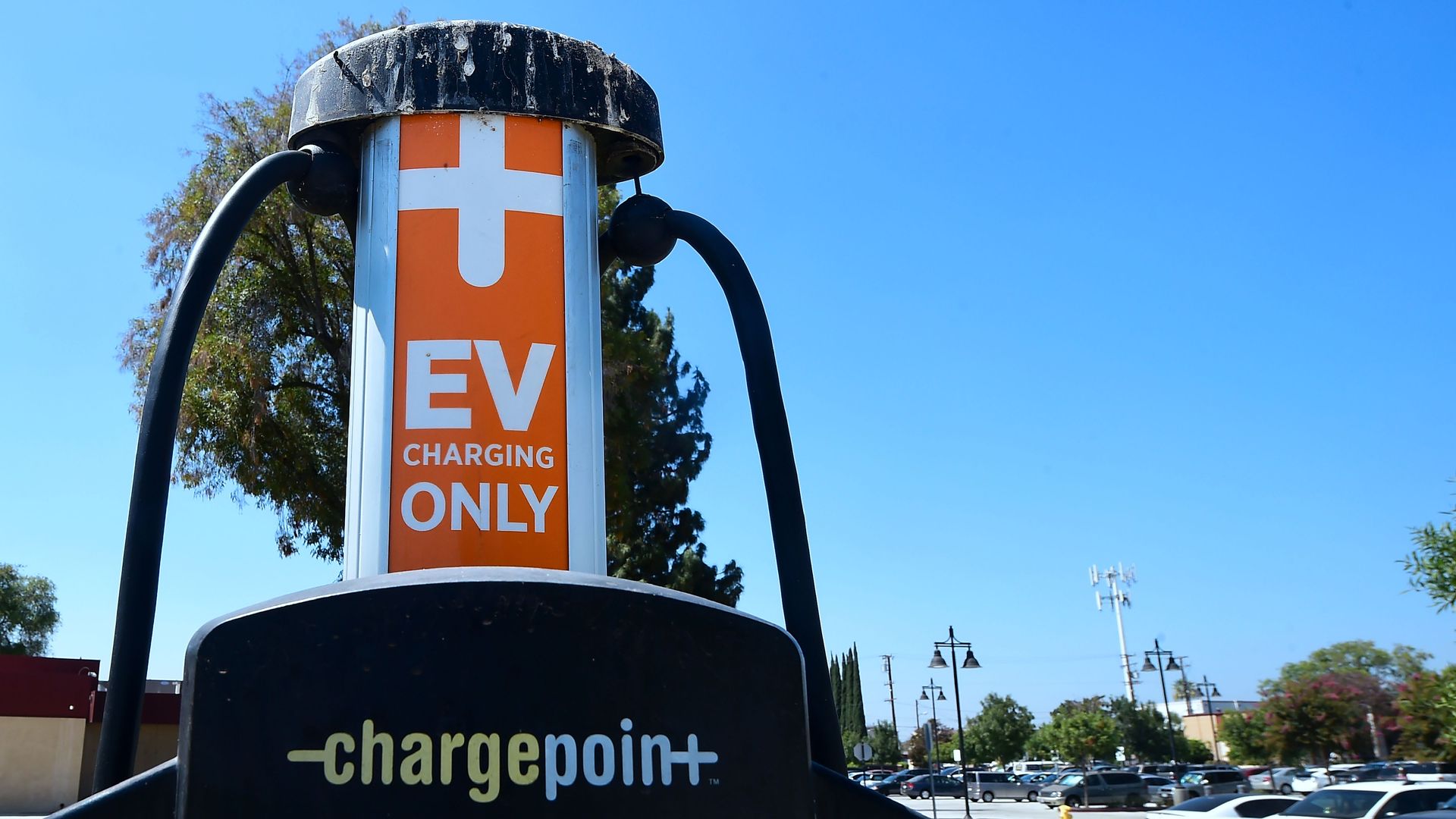 Non-electric vehicles fill a parking lot in Rosemead, California, where two Electric Vehicle charging stations are offered